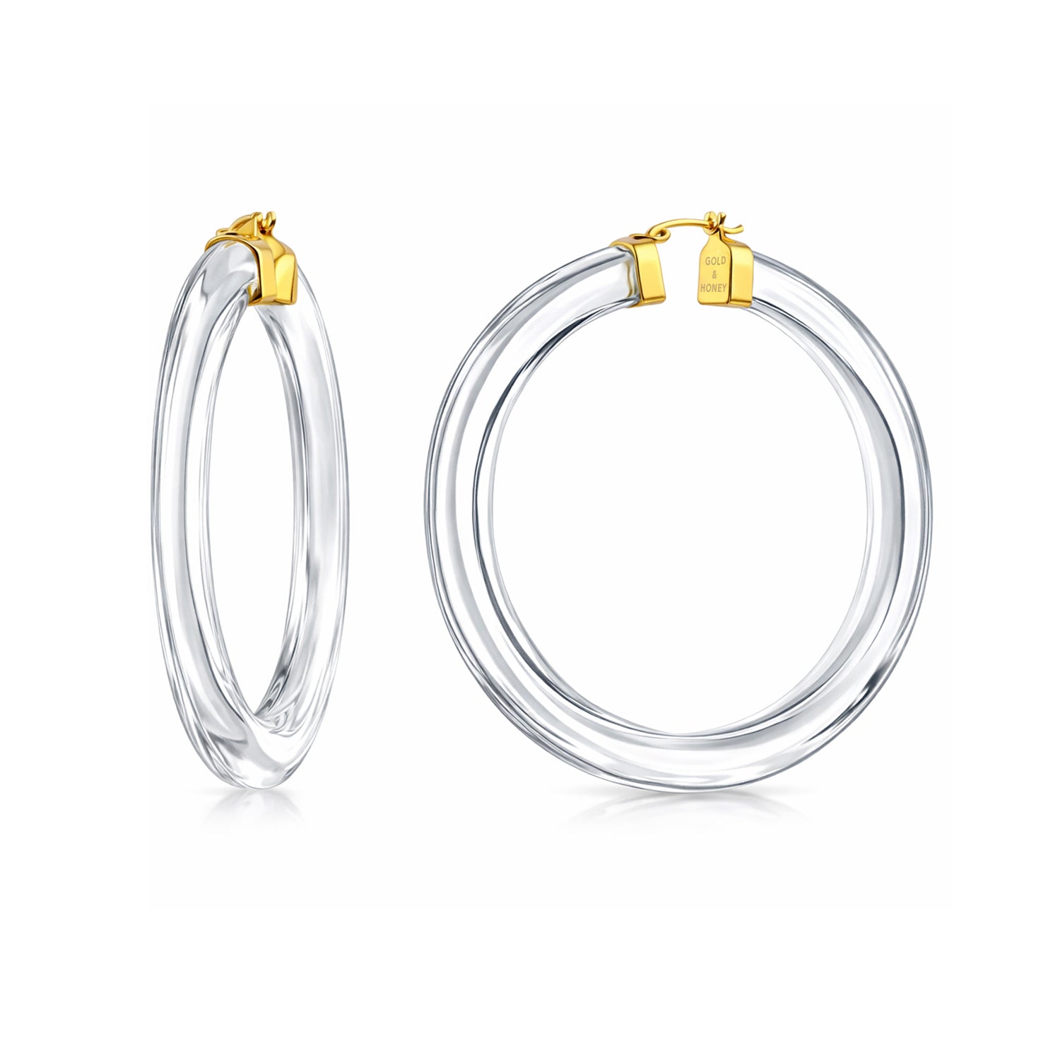 Clear hoop earrings with gold accents on a white background