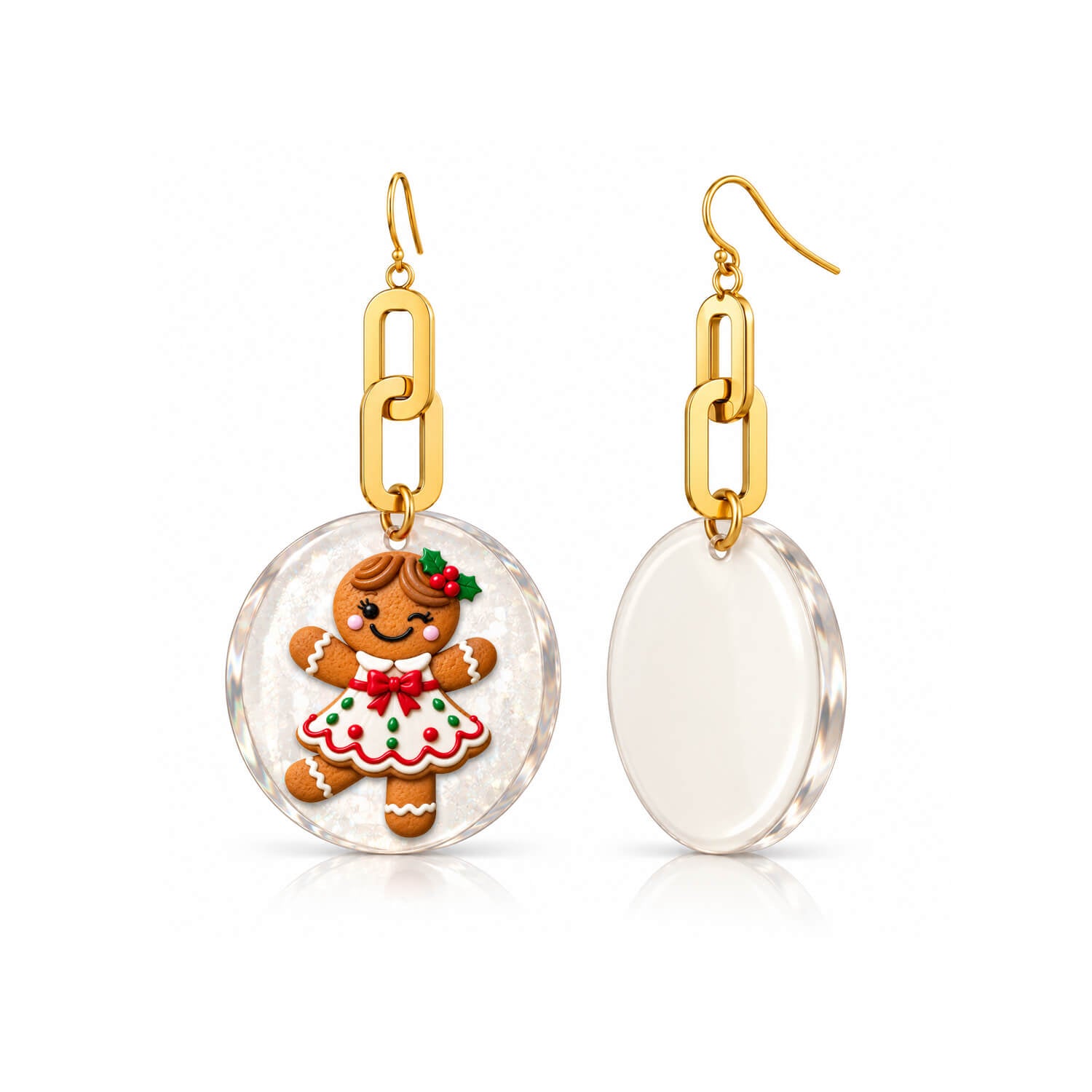 A pair of gold-tone dangle earrings with oval clear resin pendants. One pendant features a festive gingerbread cookie character in a white dress with red and green icing details, while the other shows the blank, clear back of the pendant.