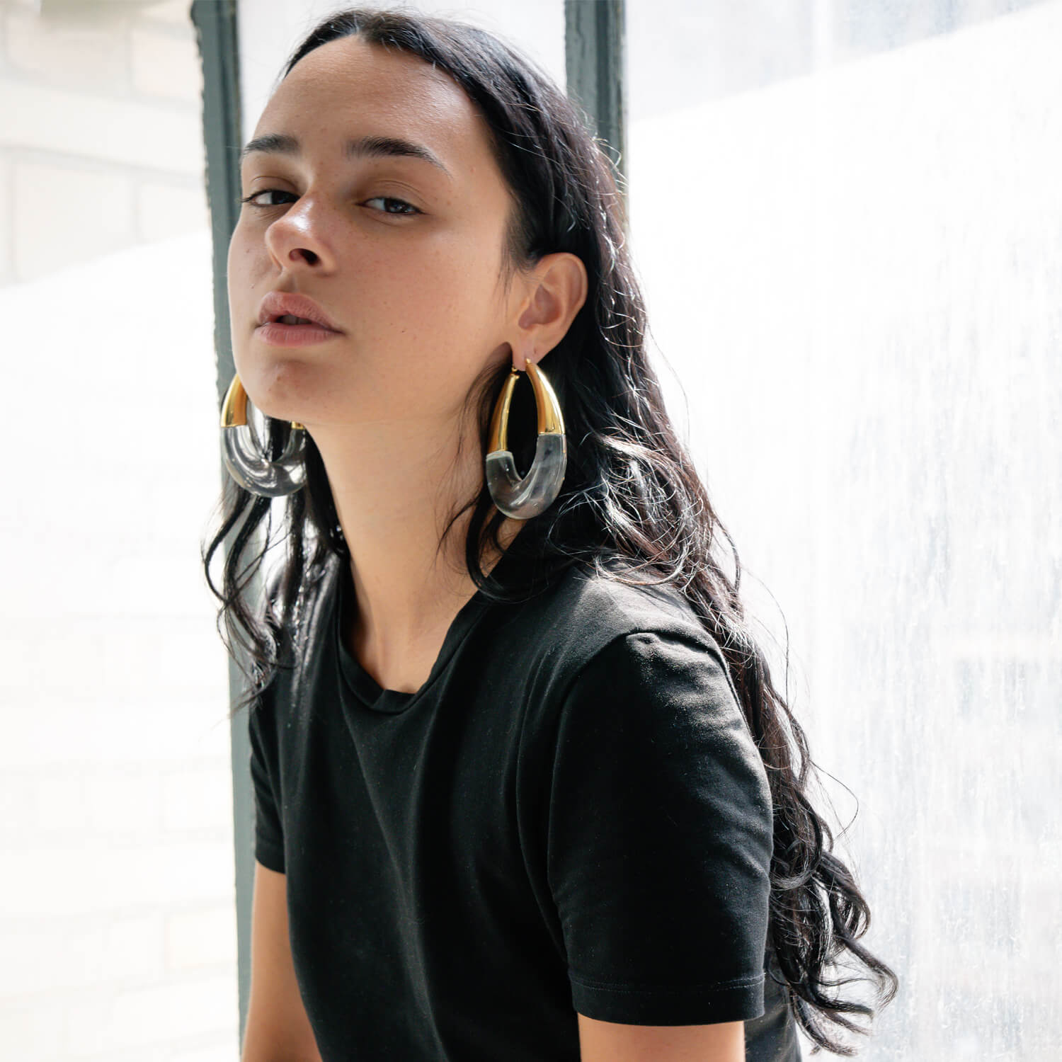 XL gold and clear bucket hoop earrings on model