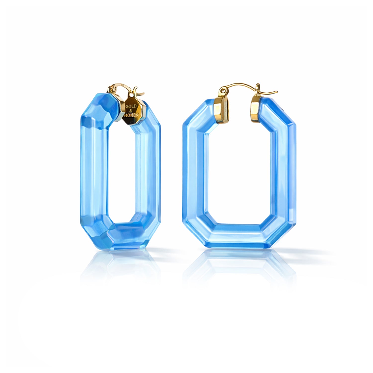 Blue hoop earrings with gold accents on a white background