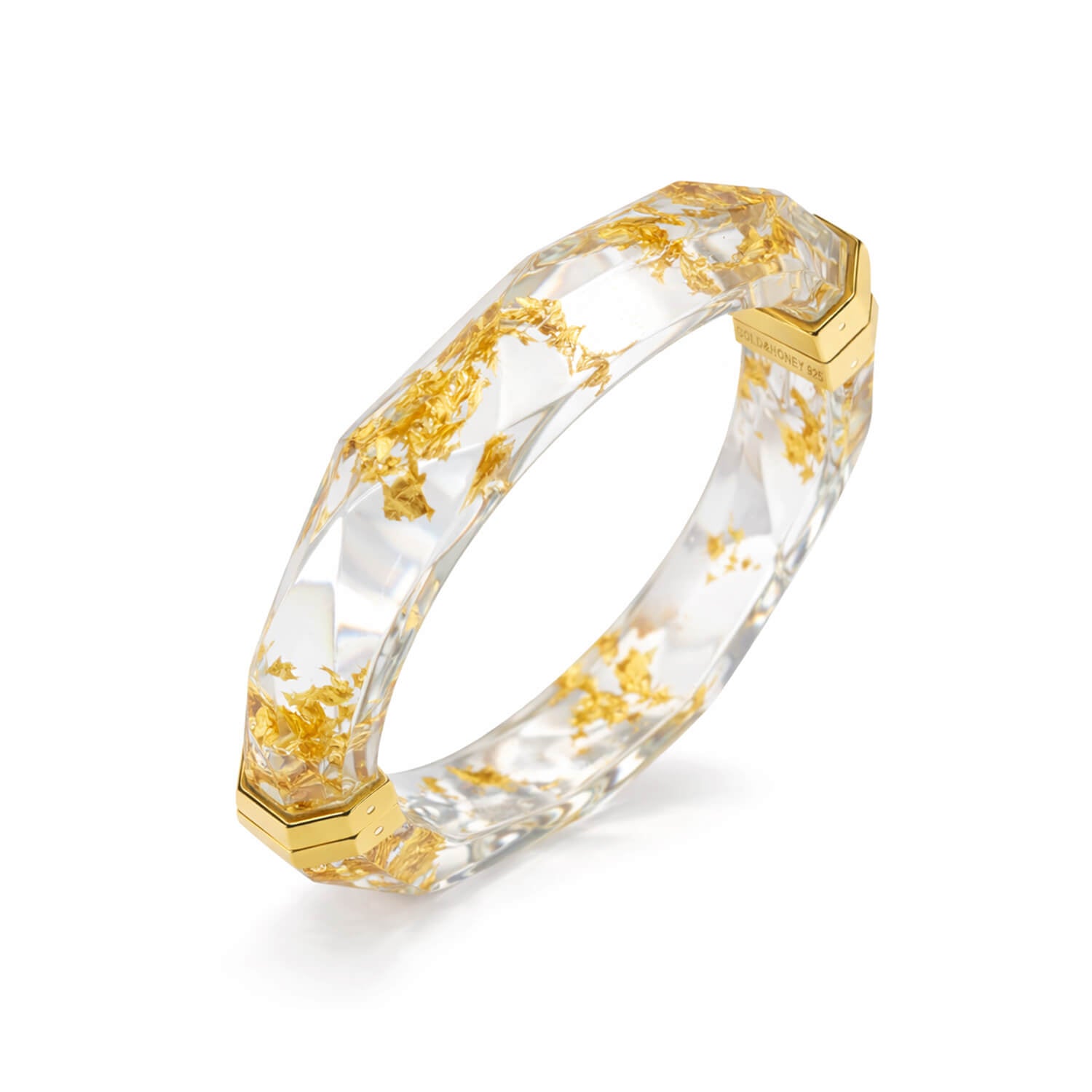 Gold and clear hexagonal ring on a white background