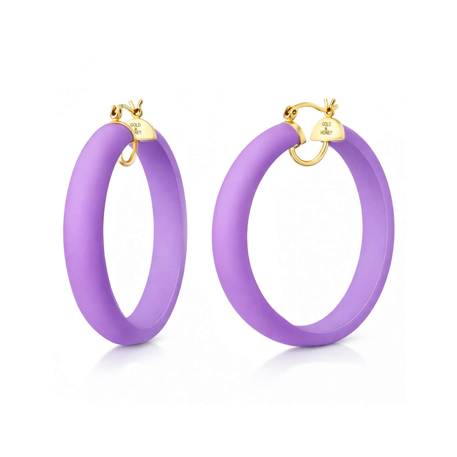 Purple hoop earrings with gold accents on a white background