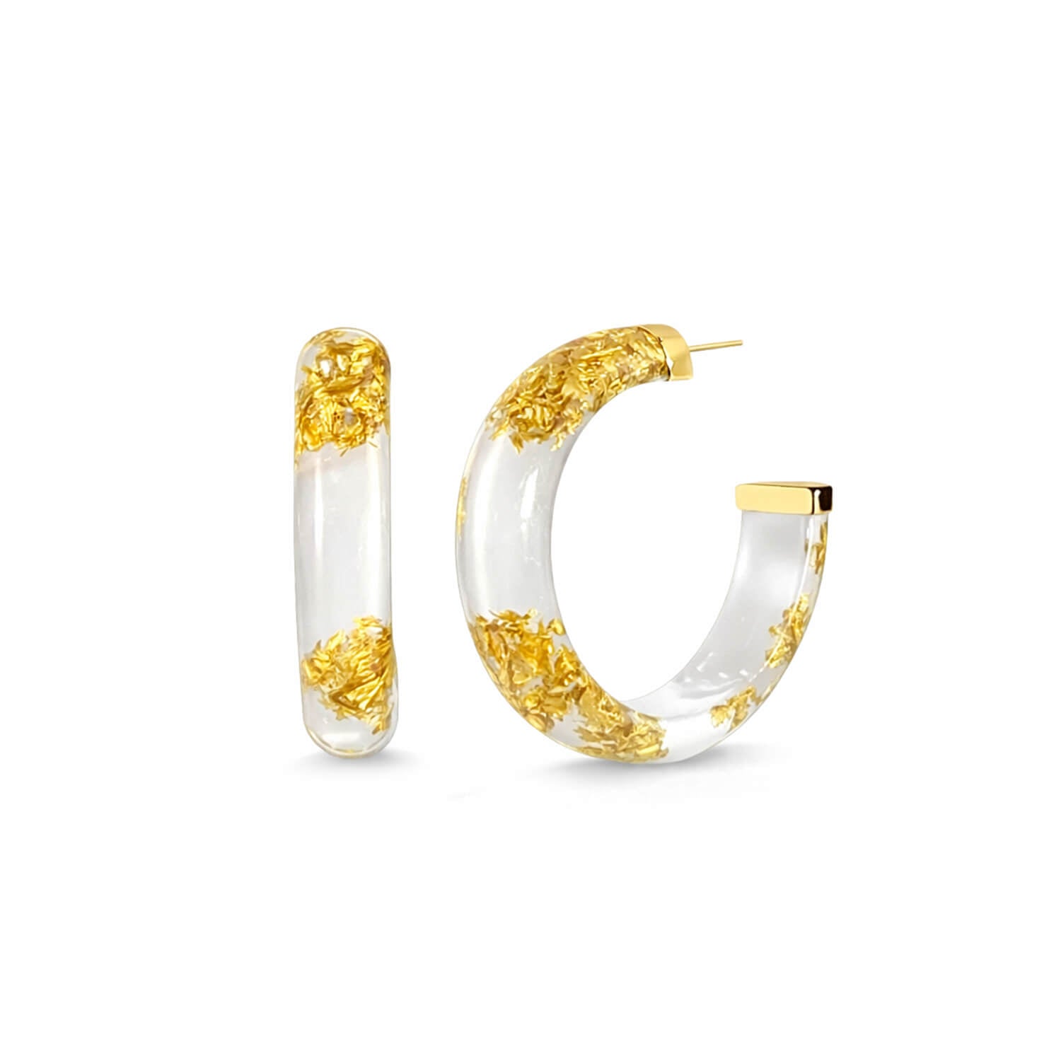 Gold and white hoop earrings on a white background