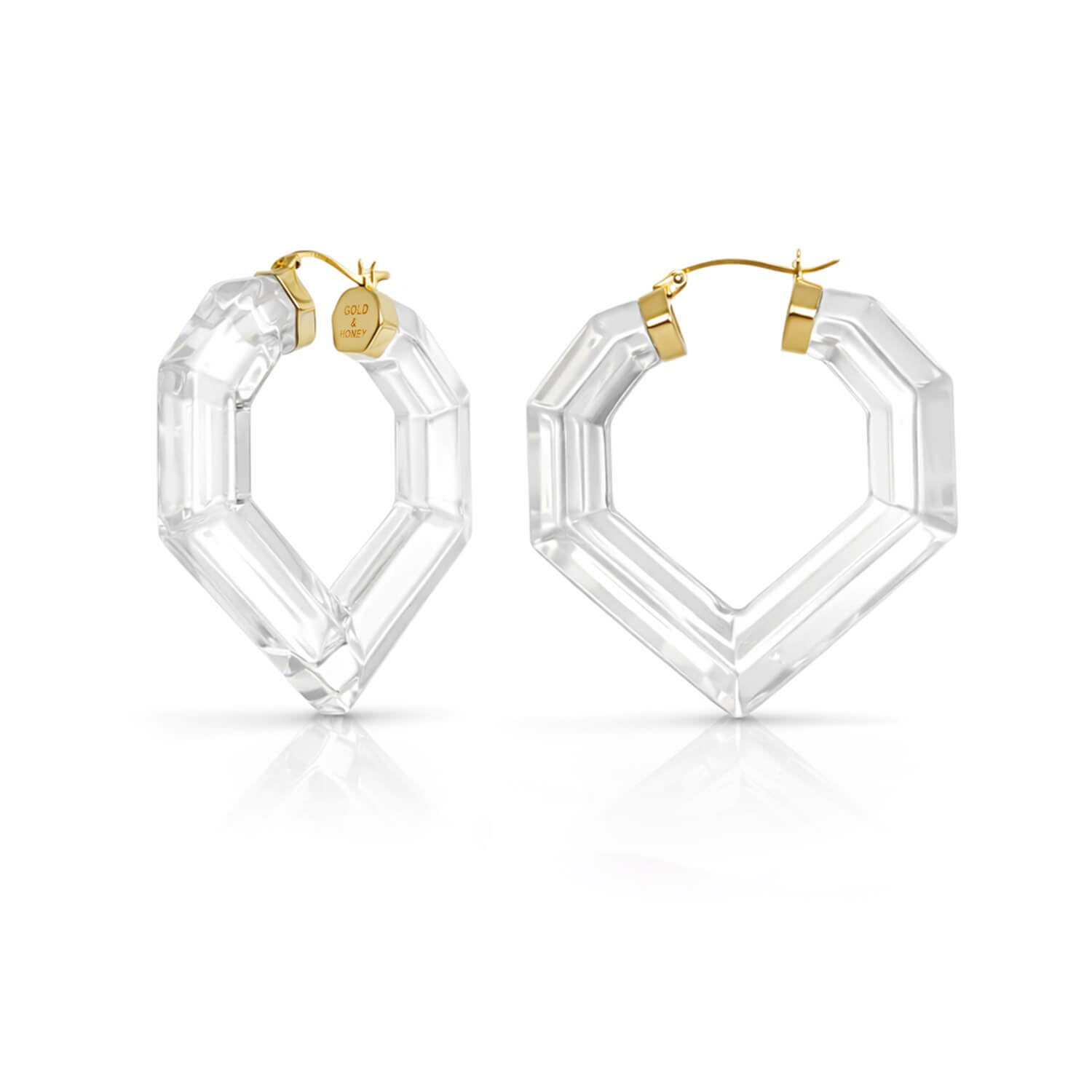 Clear hexagonal hoop earrings with gold accents on a white background