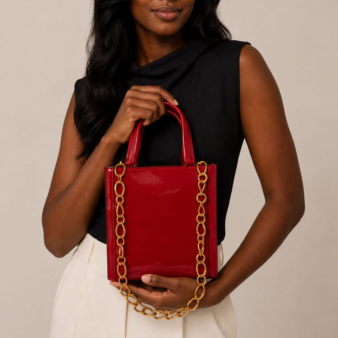 model holding a red bag with gold modern link chain