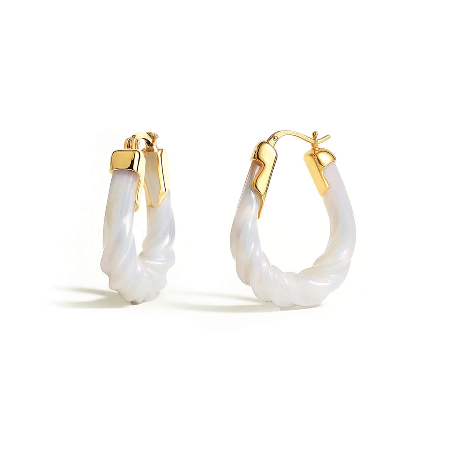 Gold hoop earrings with white on a white background