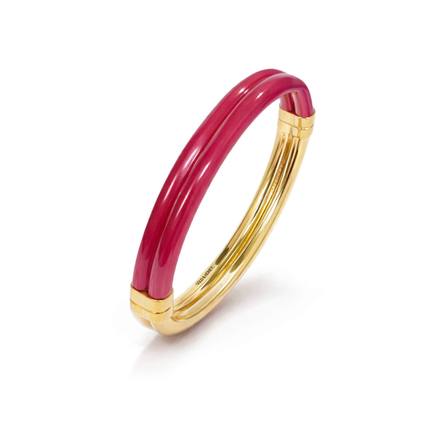 Gold bracelet with a pink band on a white background