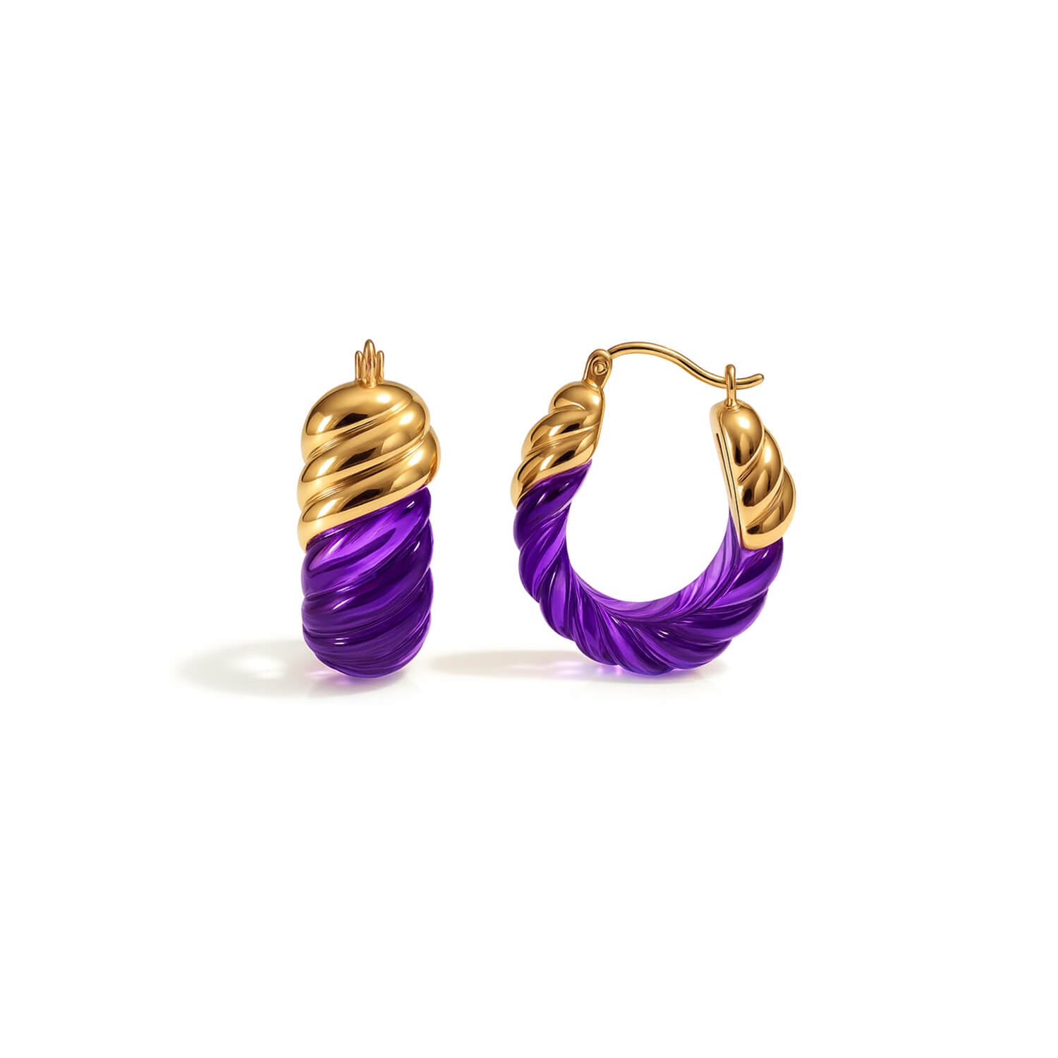 Gold and purple hoop earrings on a white background