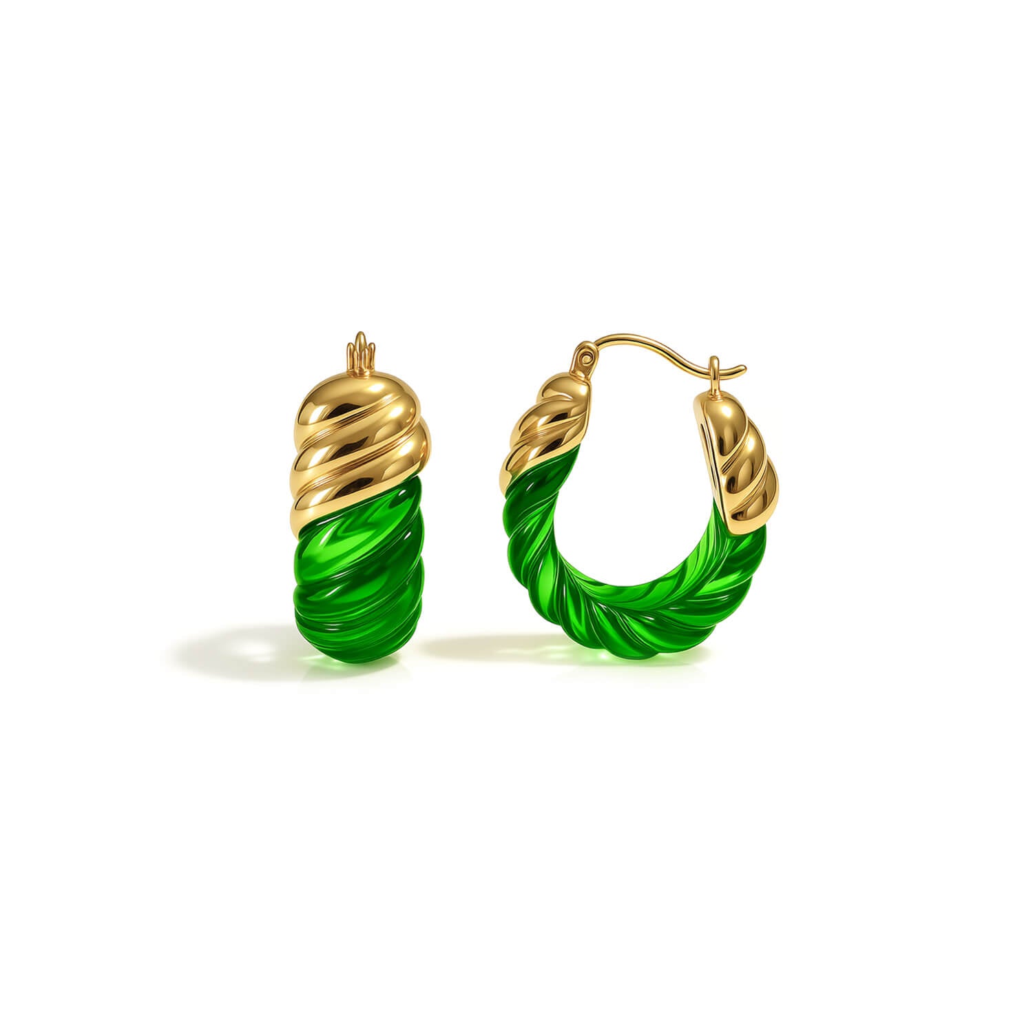 Gold and green hoop earrings on a white background