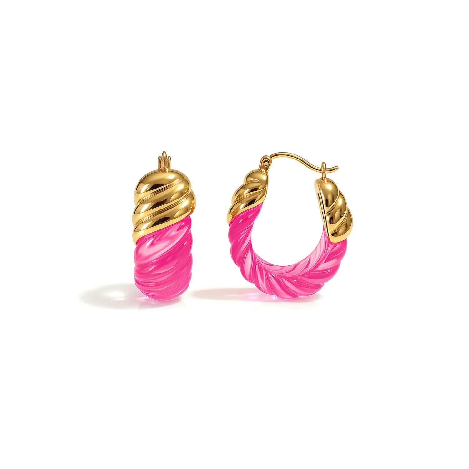 Gold and pink hoop earrings on a white background