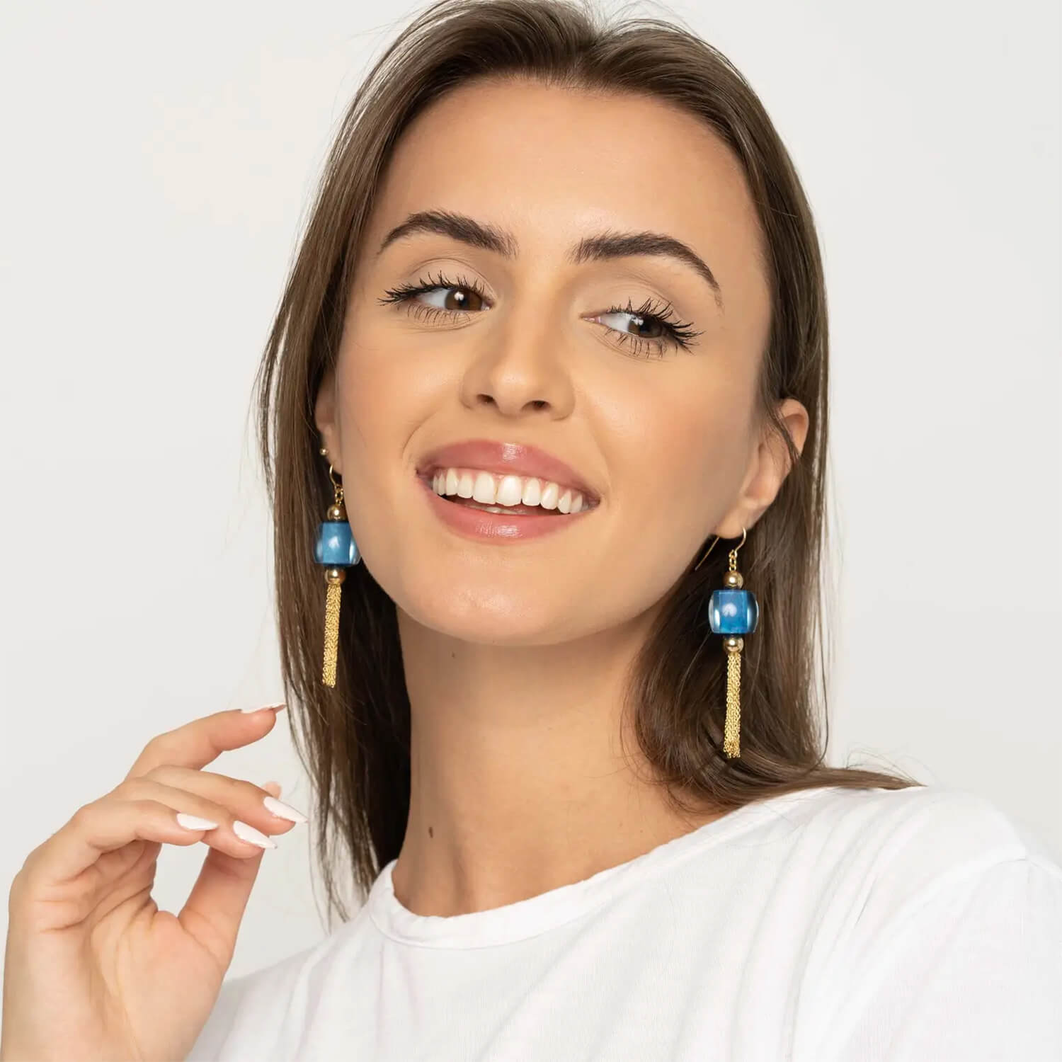 model wearing blue bead tassel earrings