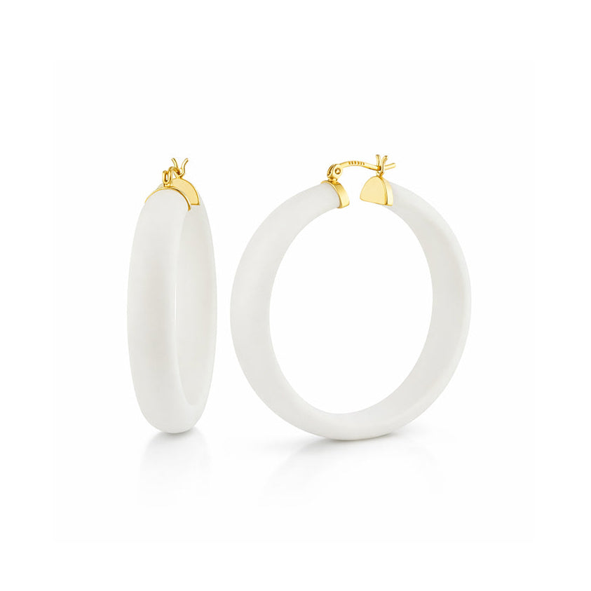 White hoop earrings with gold accents on a white background
