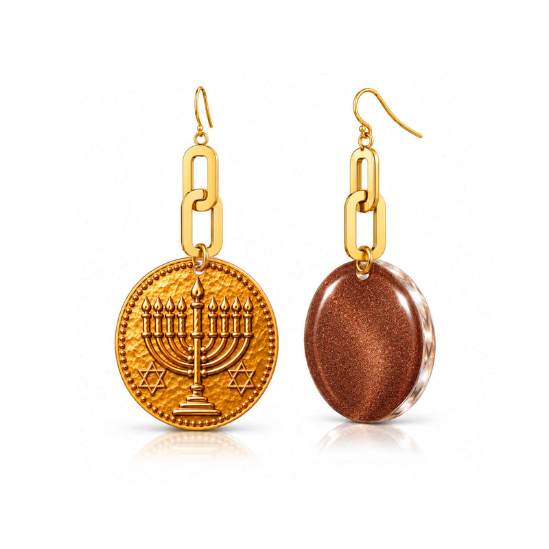 A pair of gold-tone dangle earrings on a white background. One earring features a round pendant with an embossed menorah and Star of David, while the other shows the back of a larger oval pendant with a metallic bronze glitter finish and a gold chain link connector.