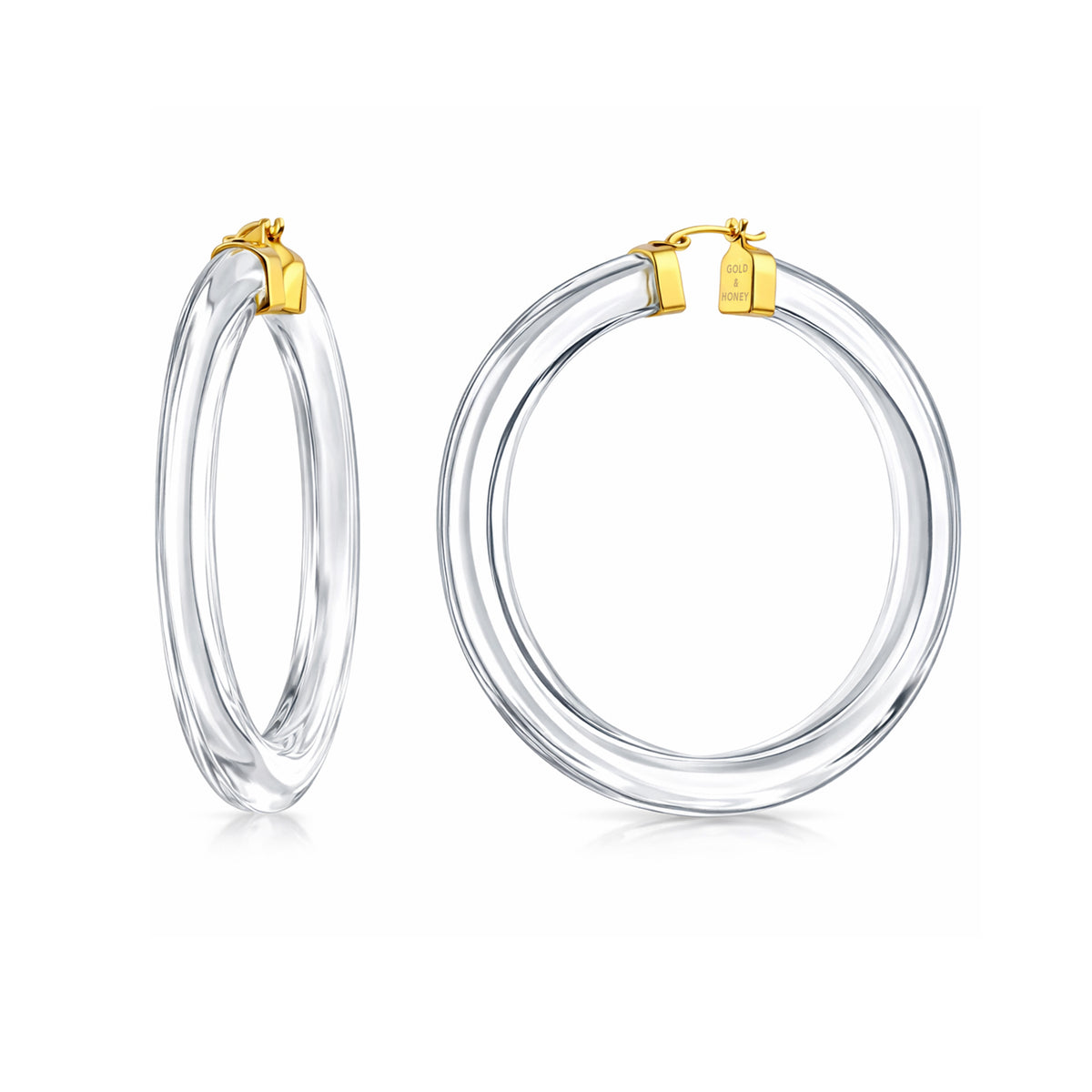 Clear hoop earrings with gold accents on a white background