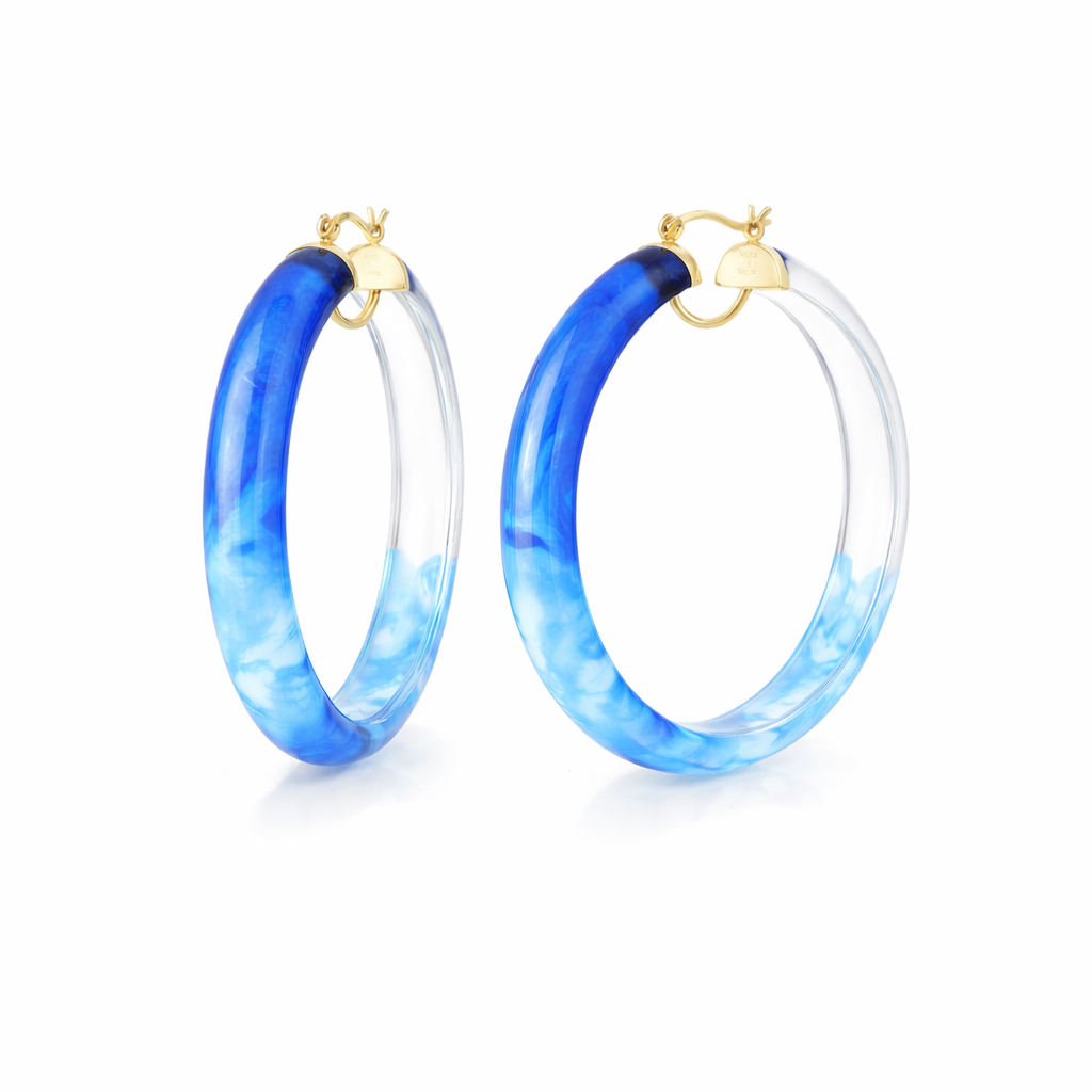 Blue marbled hoop earrings with gold accents on a white background