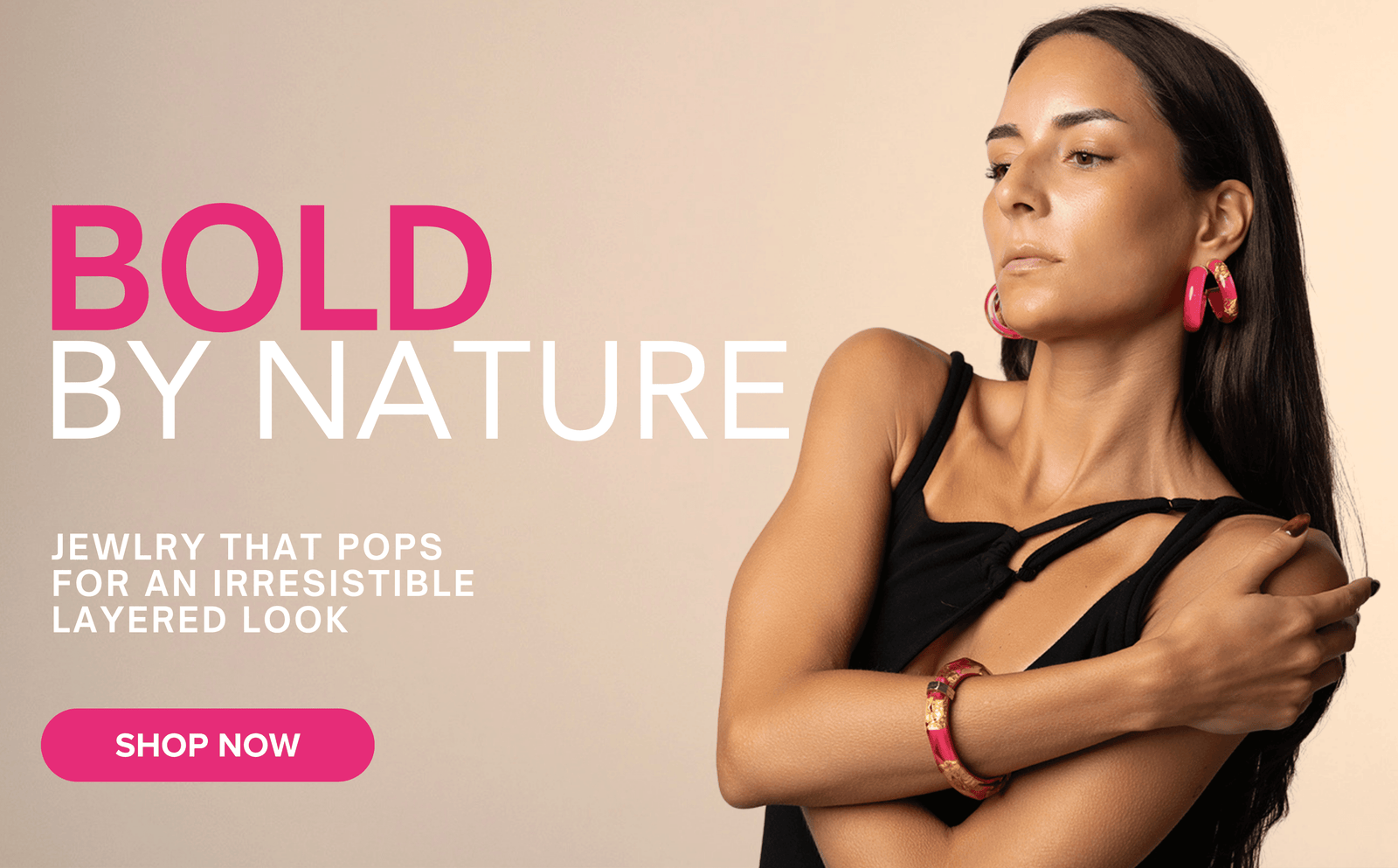 A promotional banner featuring a woman with long dark hair wearing bright pink jewelry, including a large hoop earring and a bracelet, against a beige background with the text 'BOLD BY NATURE' and a 'SHOP NOW' button.
