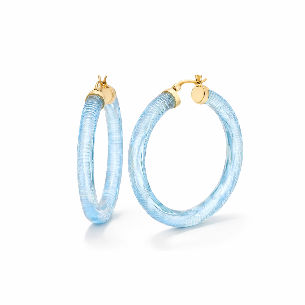 Pair of light blue hoop earrings with gold accents on a white background