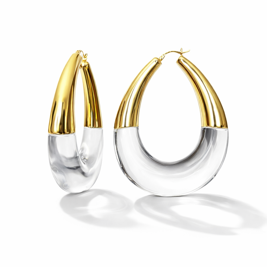 Gold and clear hoop earrings on a white background