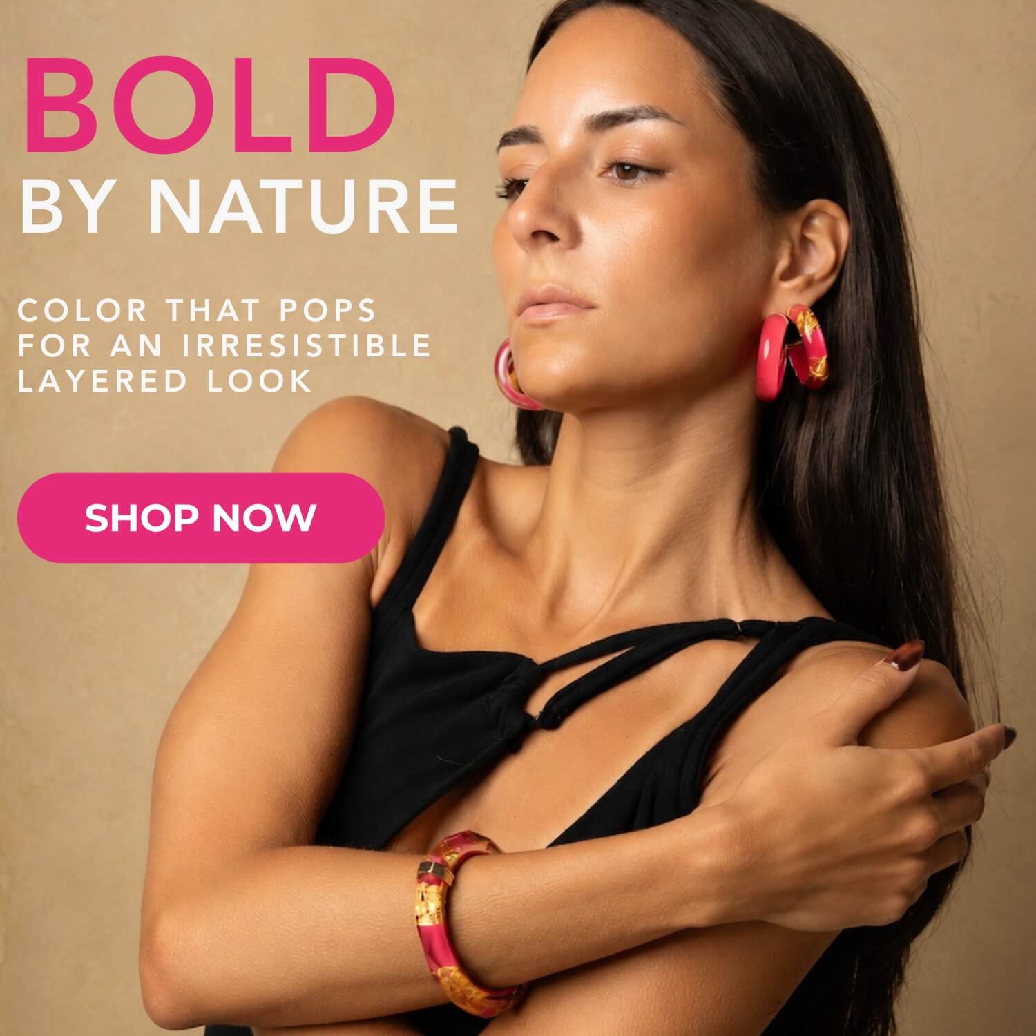 A woman wearing bright pink and gold layered earrings and a matching bracelet, posed against a warm beige background with promotional text reading 'BOLD BY NATURE' and 'SHOP NOW'.