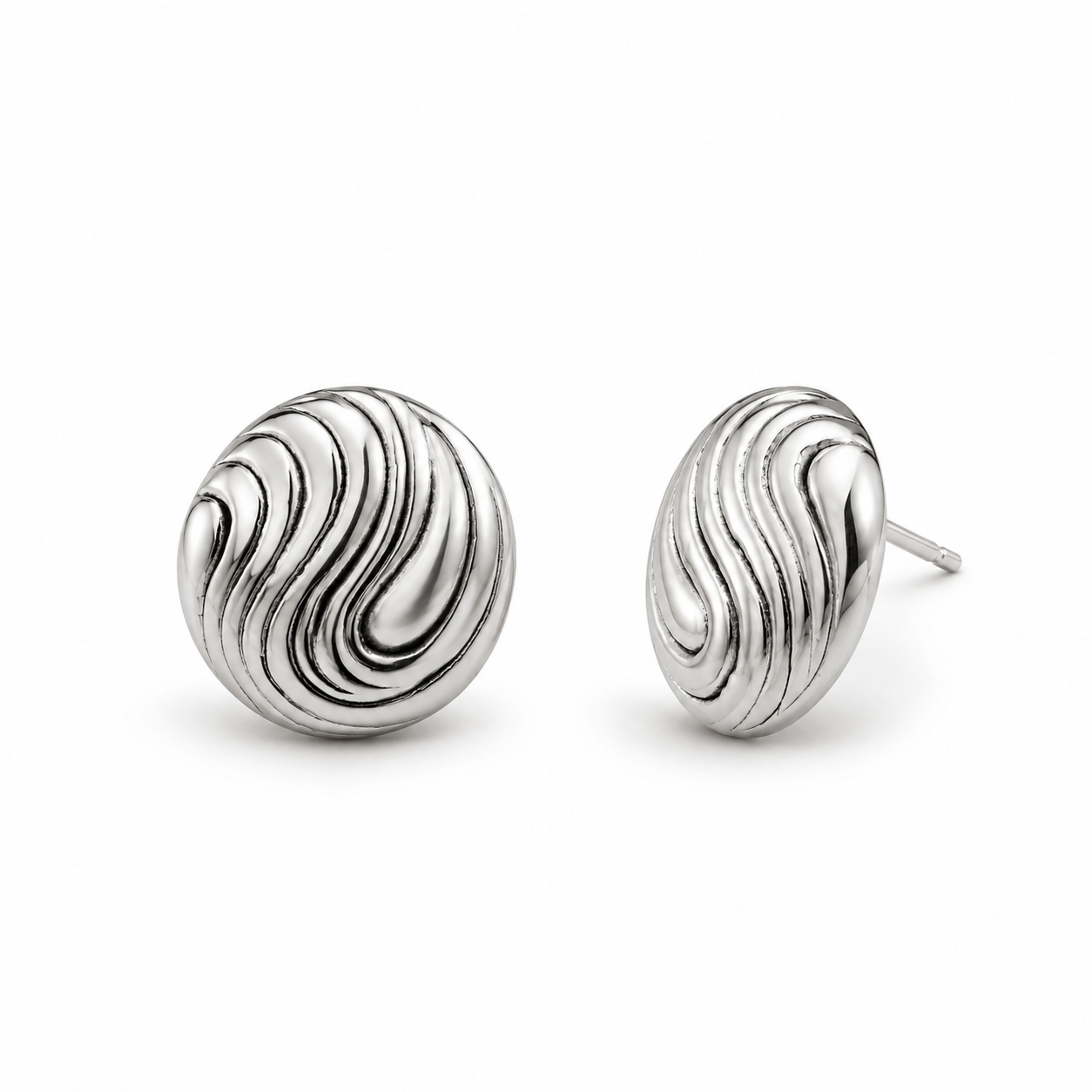 Pair of silver earrings with wavy design on a white background