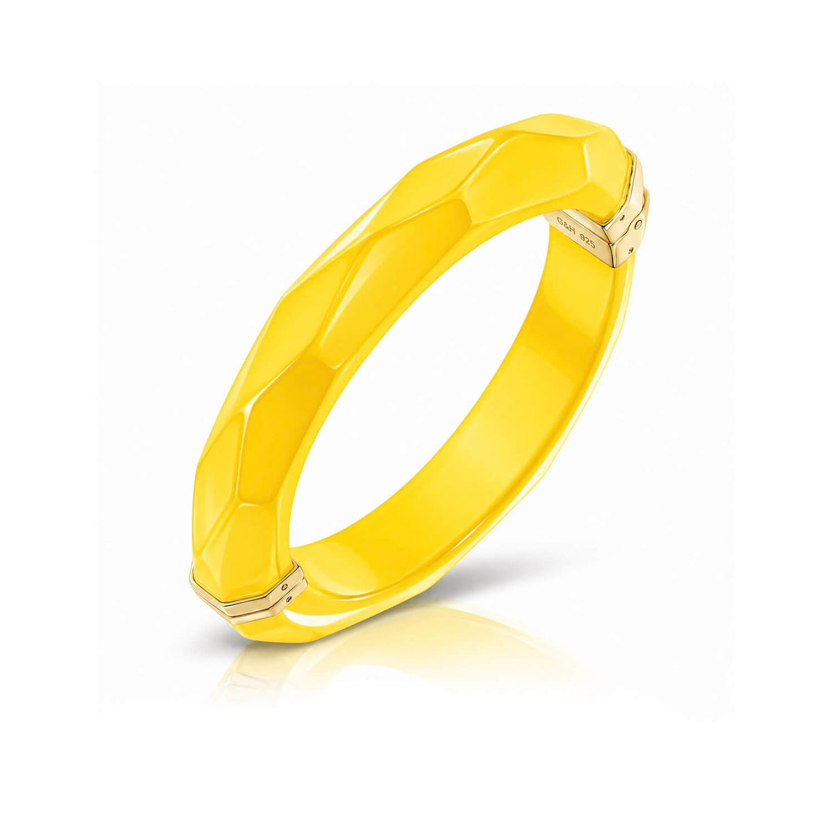 yellow faceted bangle on white background
