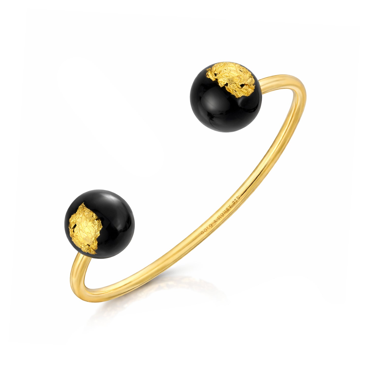 Gold bracelet with black beads featuring gold accents on a white background