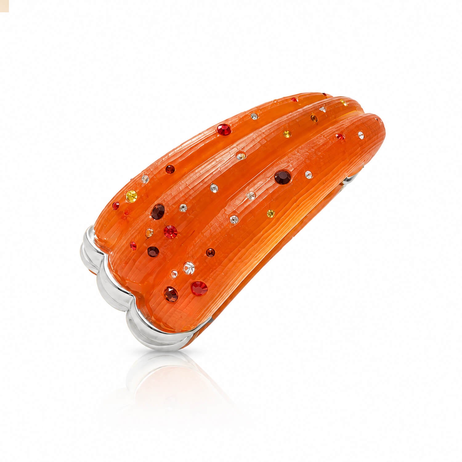 Orange decorative item with embedded gemstones on a white background