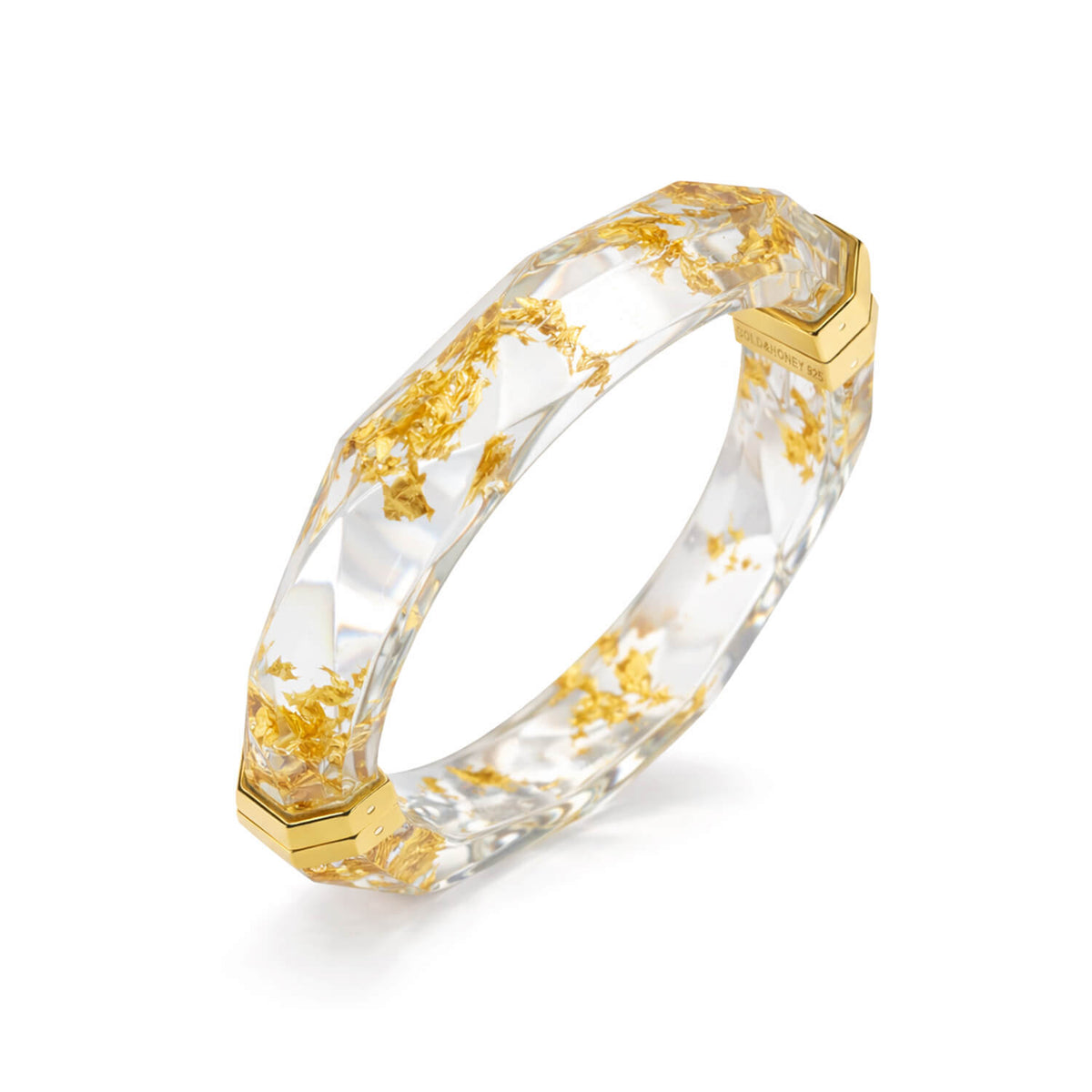 Gold and clear hexagonal ring on a white background