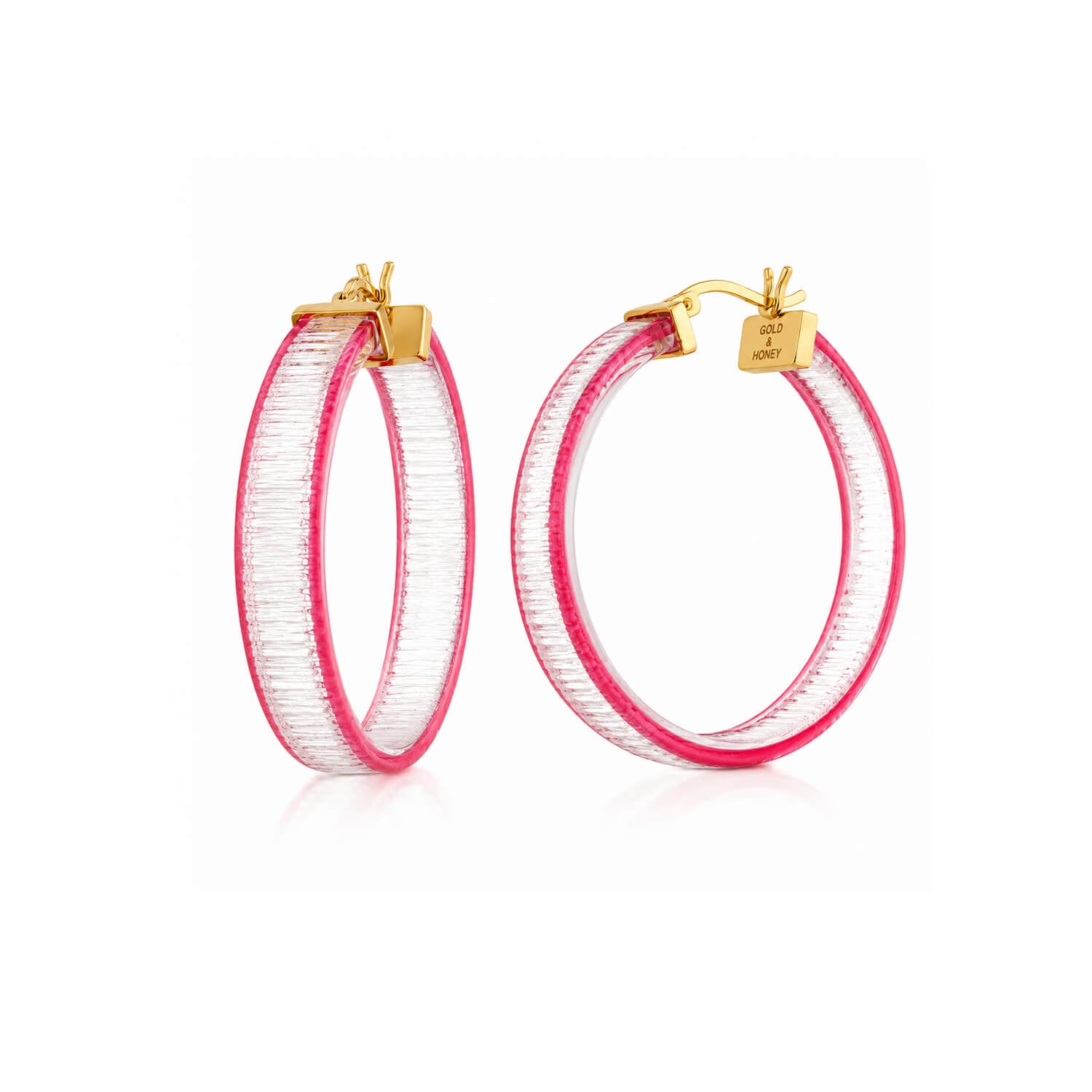 A pair of gold hoop earrings with a textured, ribbed pink and clear outer band, shown on a clean white background.