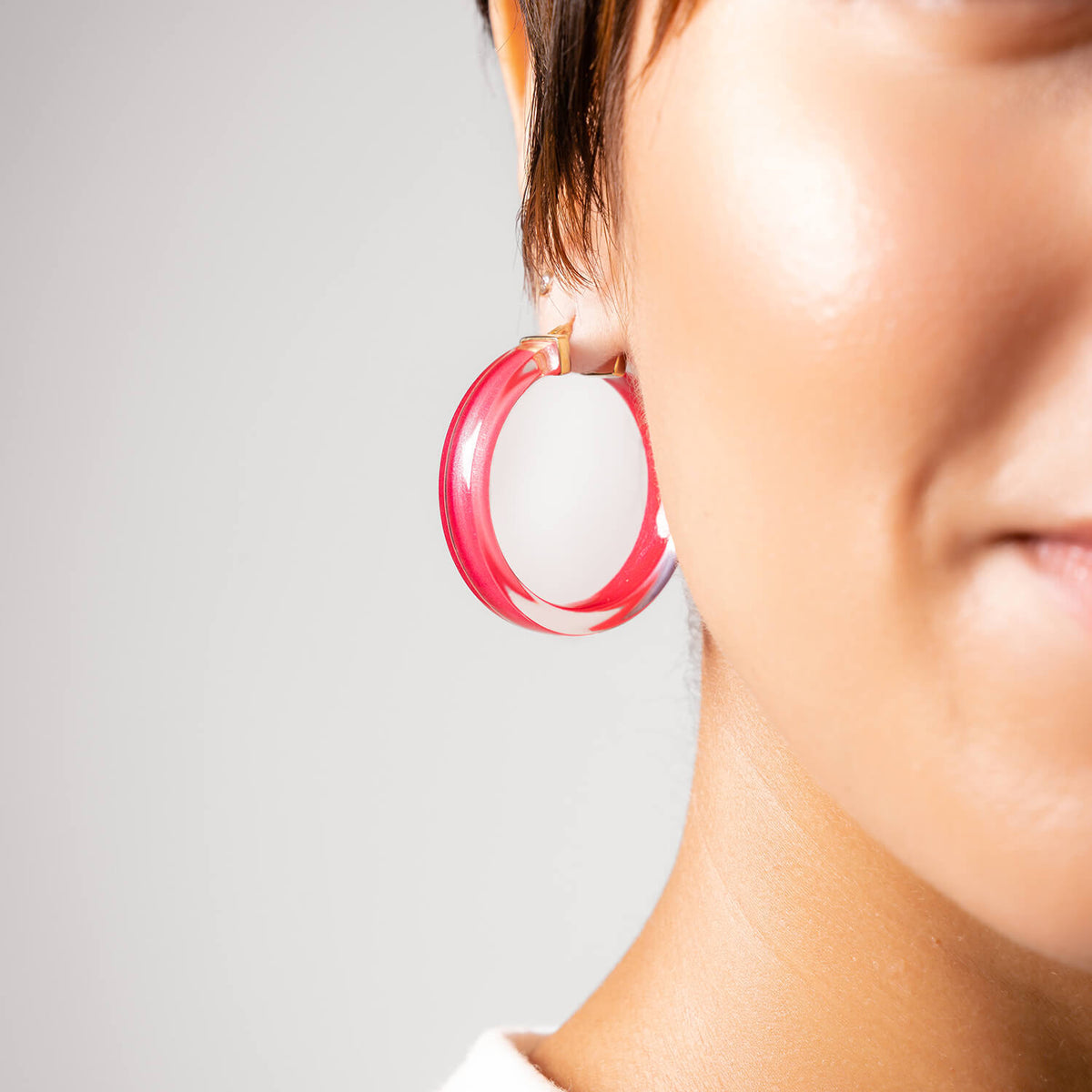 model wearing a pink earrings with gold posts