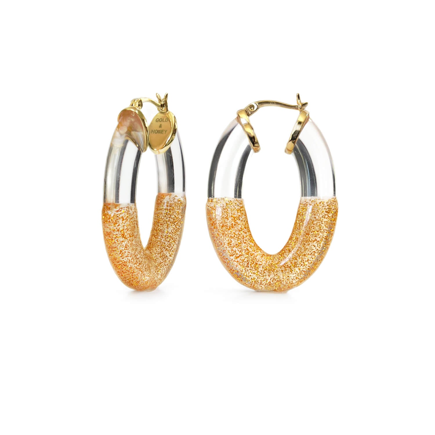 flat oval hoop earrings in clear and gold glitter