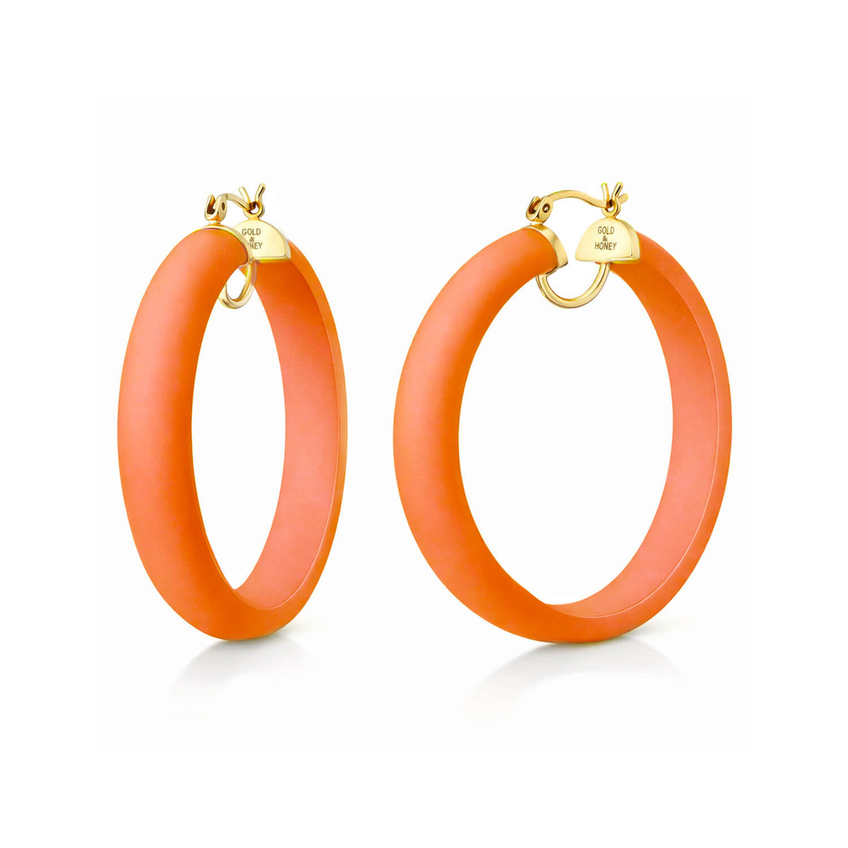 Orange hoop earrings with gold clasps on a white background