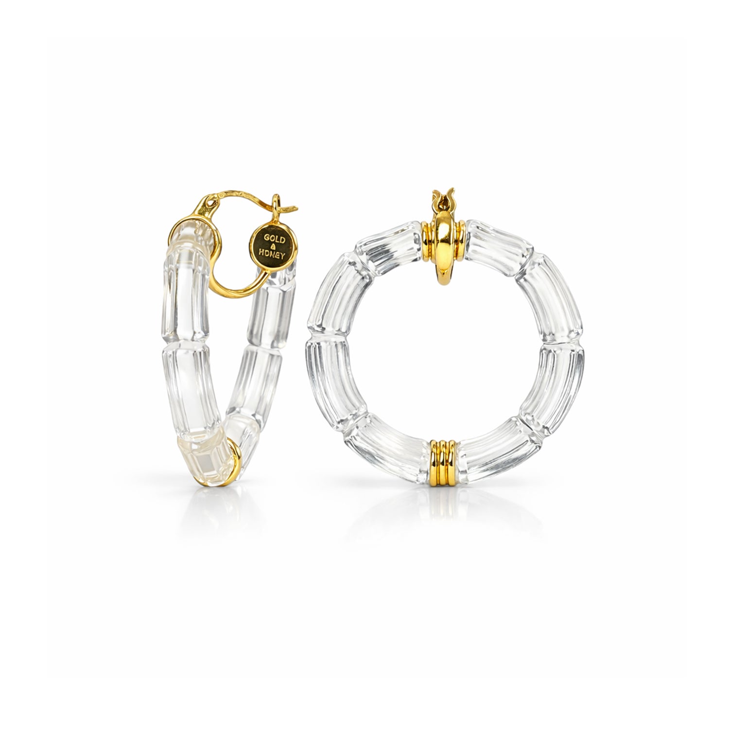Clear hoop earrings with gold accents on a white background