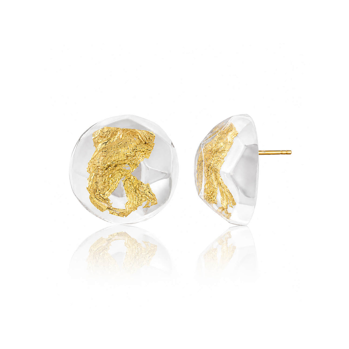 A pair of round clear resin stud earrings with textured gold leaf inlay, shown from both front and side angles on a white background with a soft reflection.