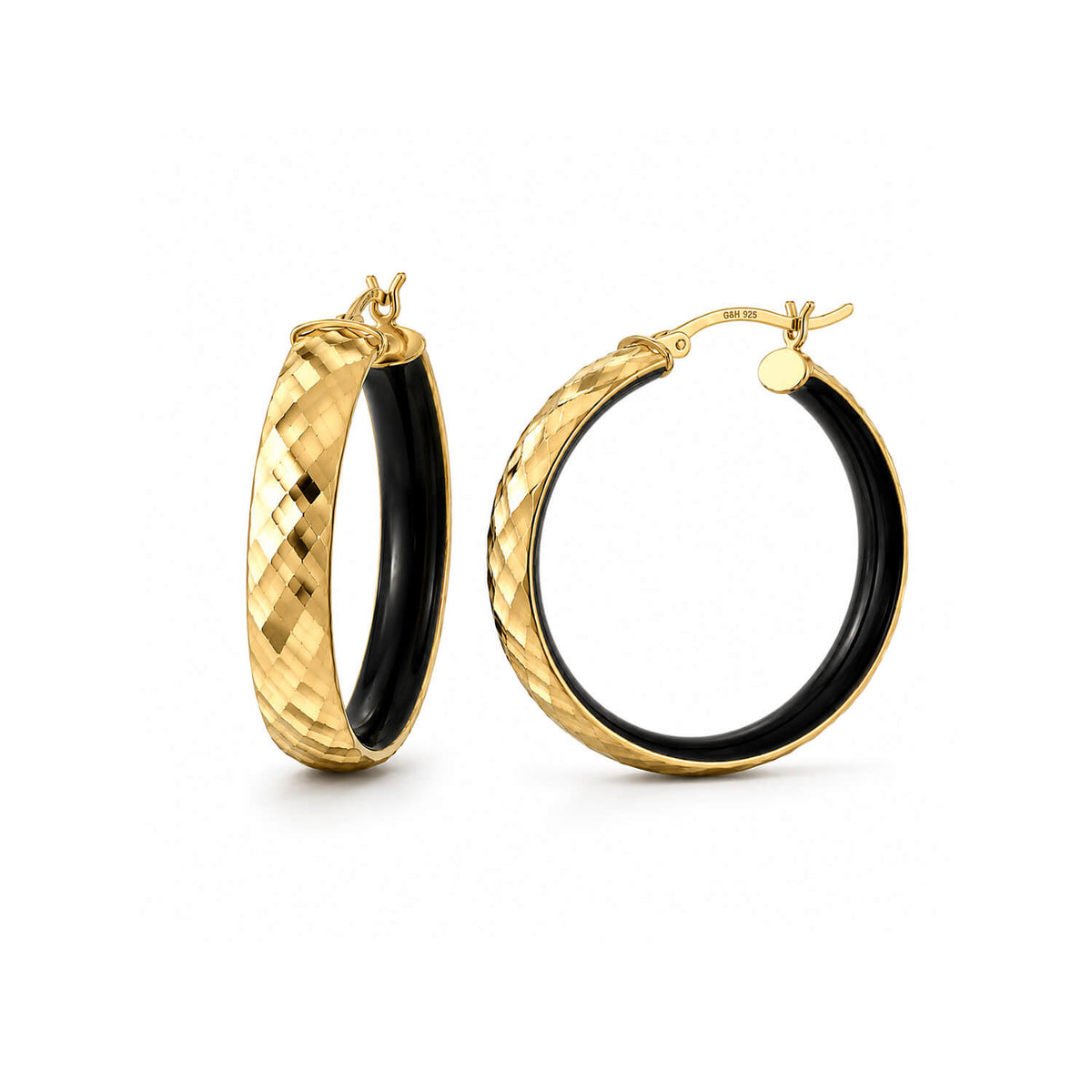 A pair of gold hoop earrings with a textured, diamond-cut exterior and a smooth black interior, shown on a clean white background.