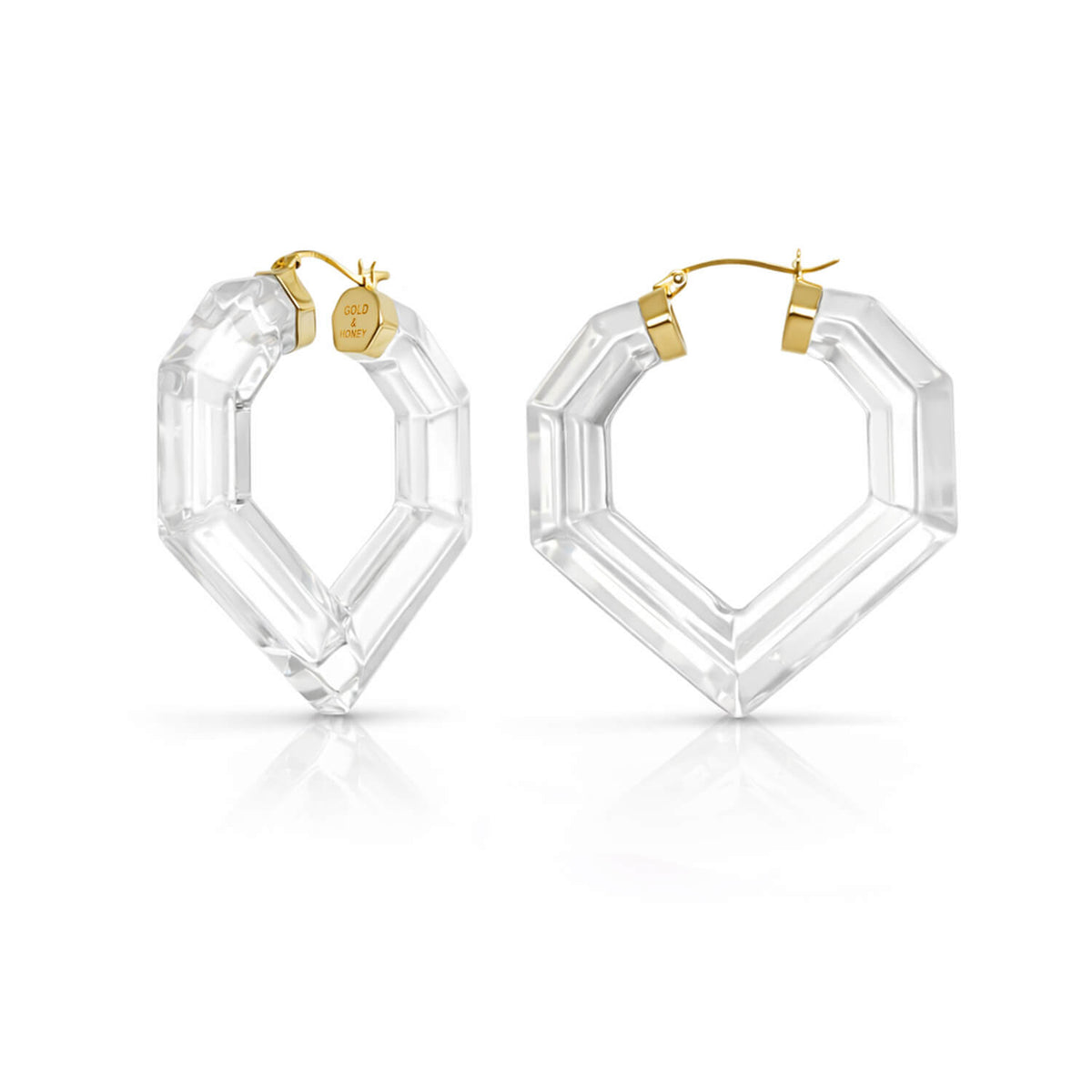 Clear hexagonal hoop earrings with gold accents on a white background