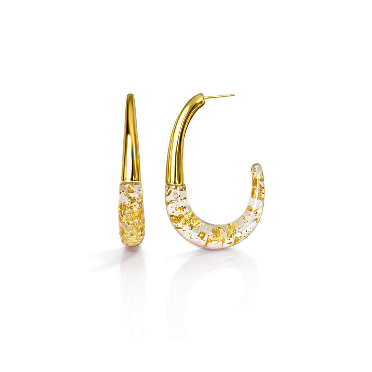 Gold hoop earrings with gold flakes on a white background
