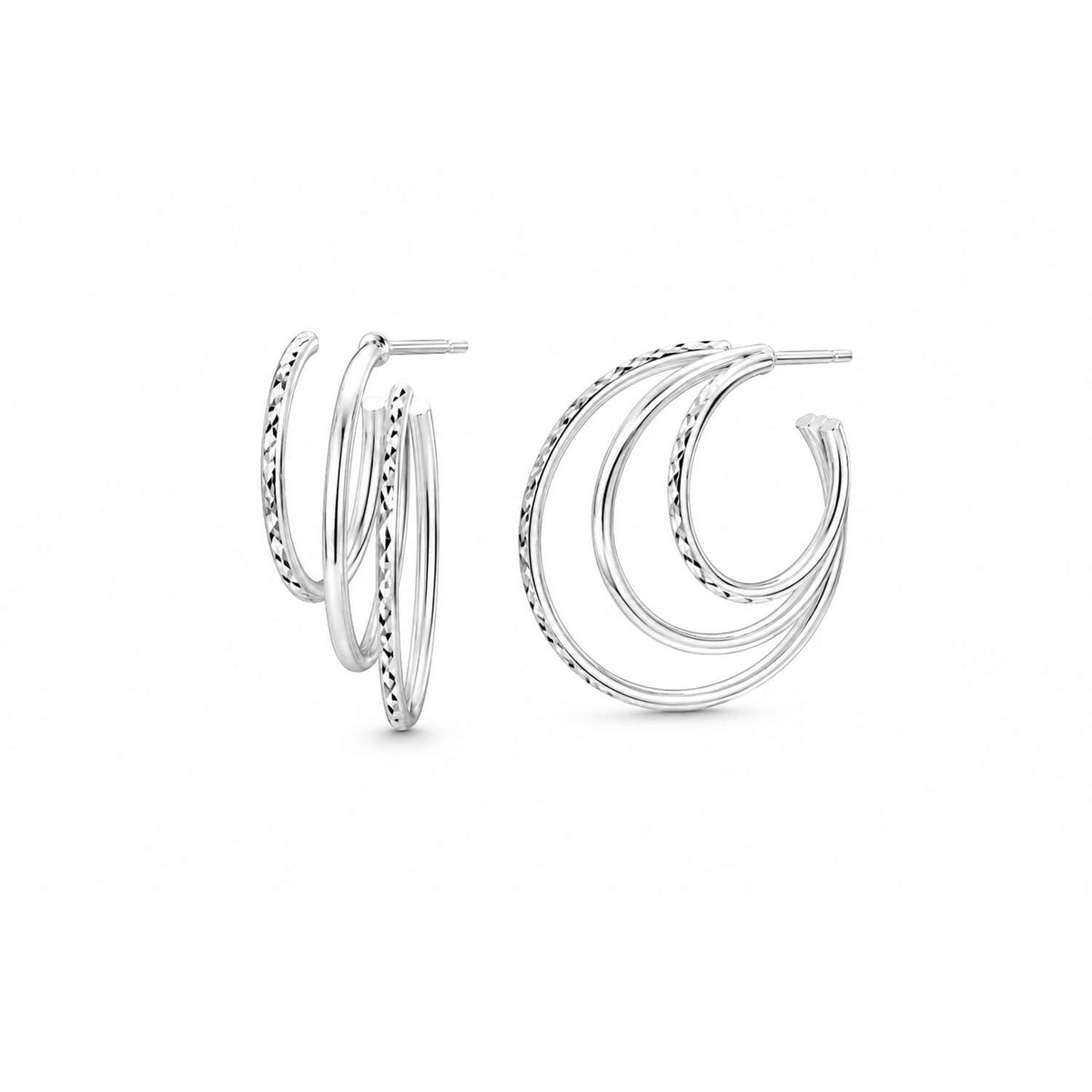 A pair of silver triple hoop earrings with textured details, displayed on a clean white background.