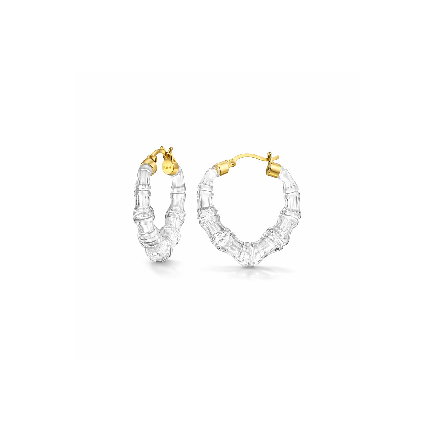 Gold and clear hoop earrings on a white background