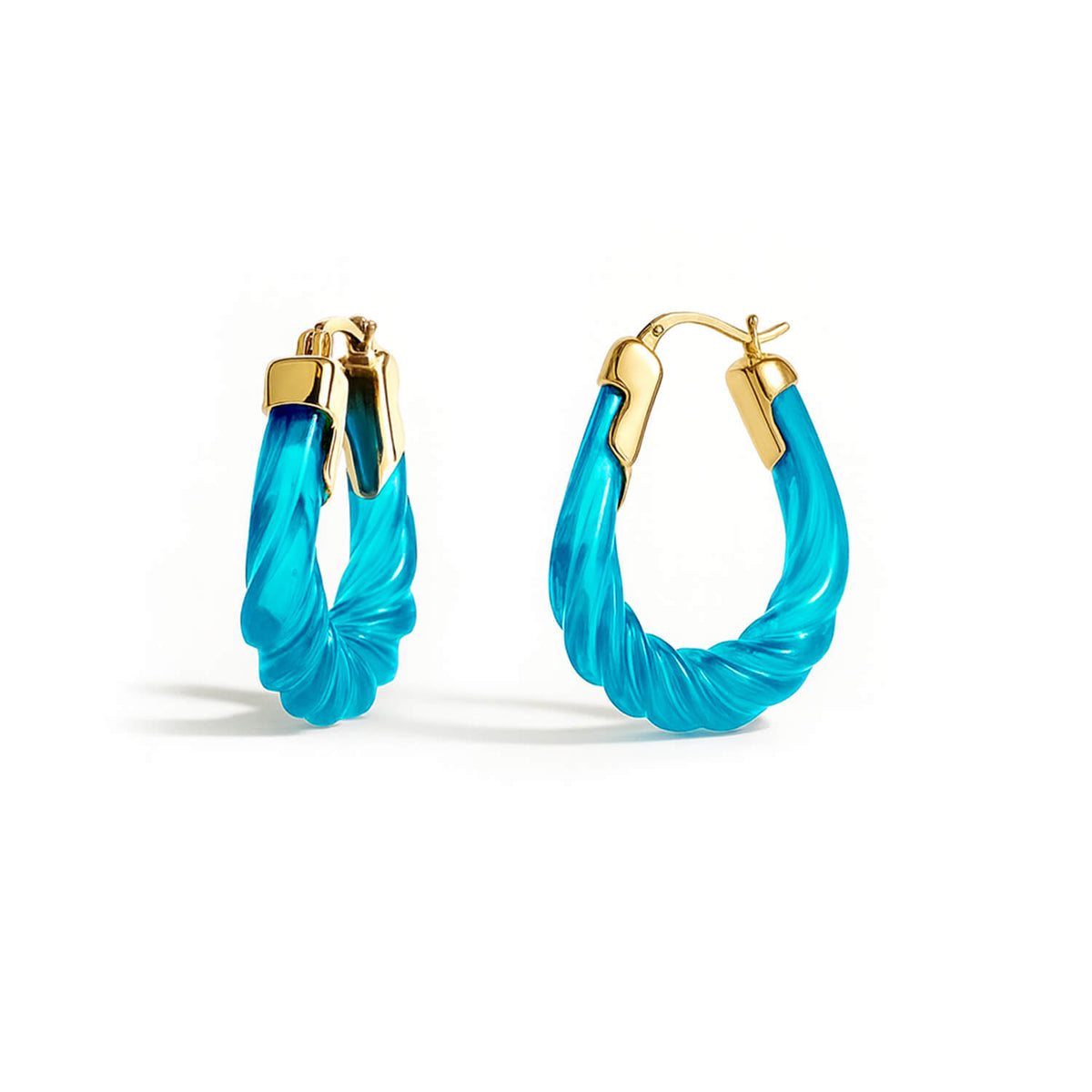 Turquoise hoop earrings with gold accents on a white background