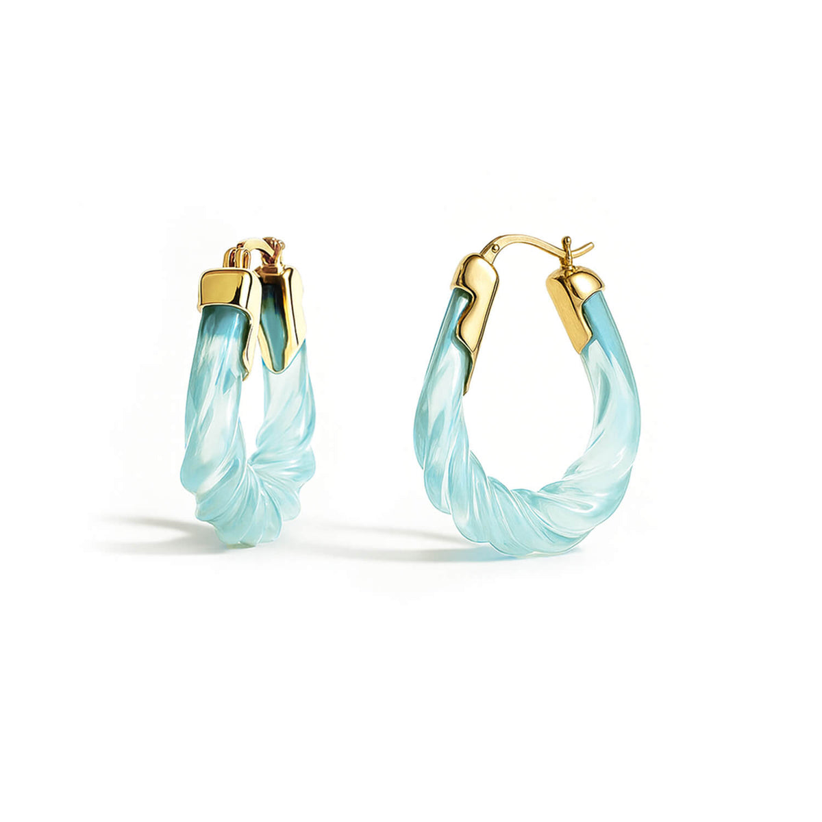 Pair of light blue hoop earrings with gold accents on a white background