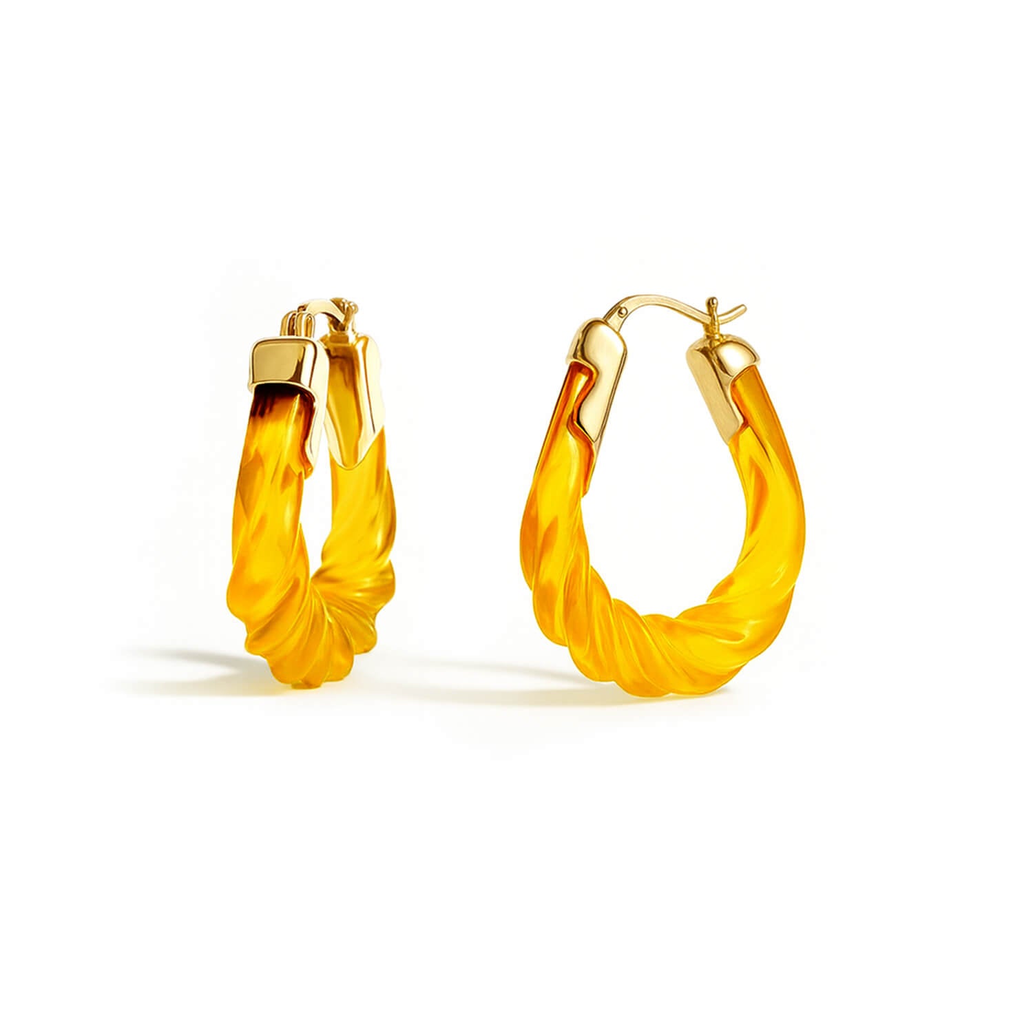 Pair of yellow hoop earrings with gold accents on a white background