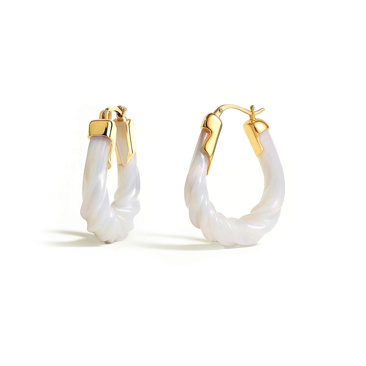 Gold hoop earrings with white on a white background