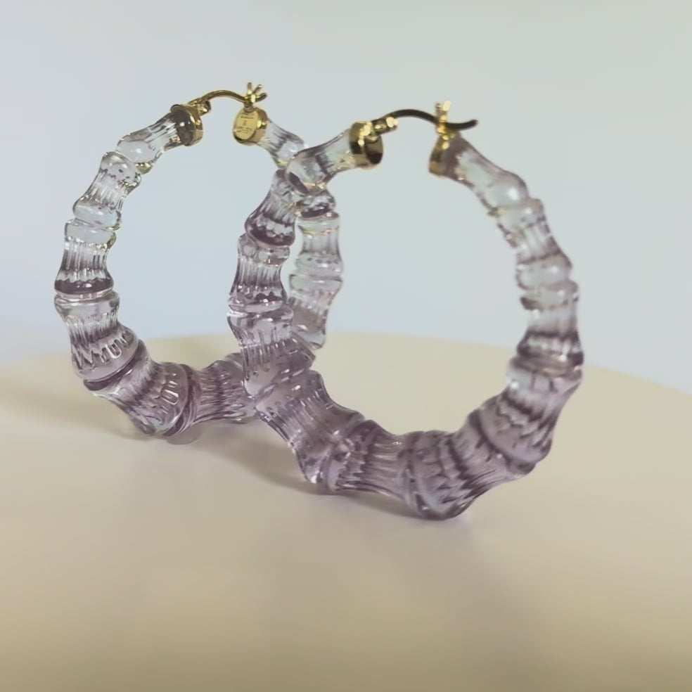 winter ombre black and purplish bamboo hoop earrings on white background - video