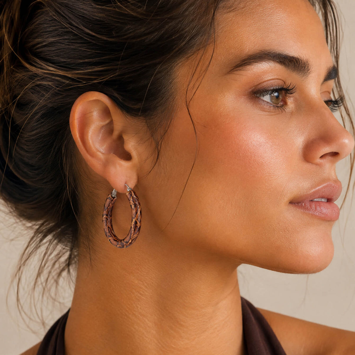 model wearing a brown python print hoop earring