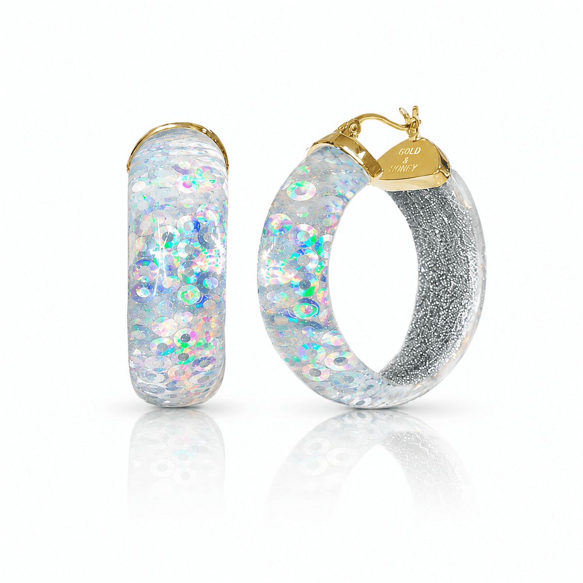 Hoop earrings with glittery finish and gold accents on a white background