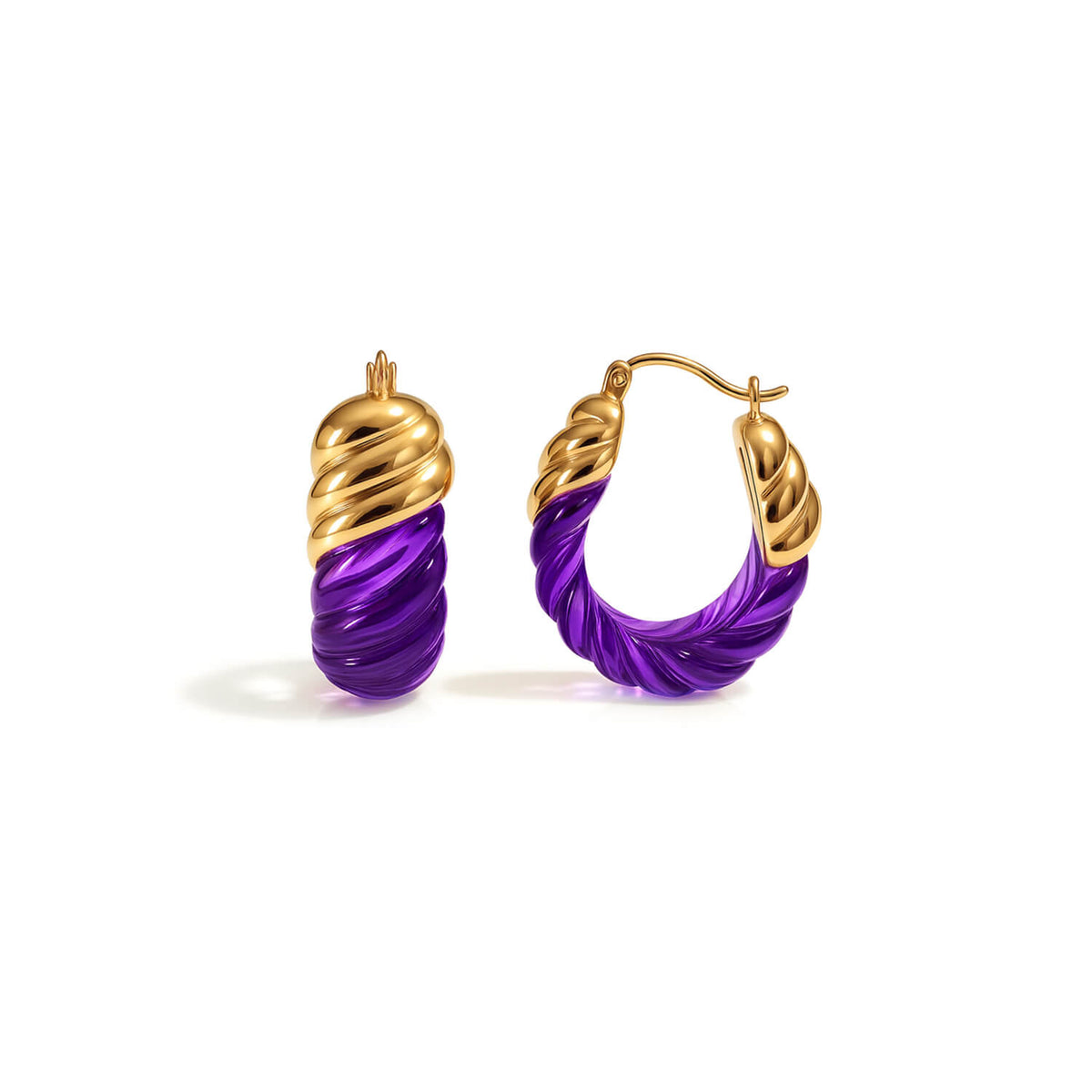 Gold and purple hoop earrings on a white background