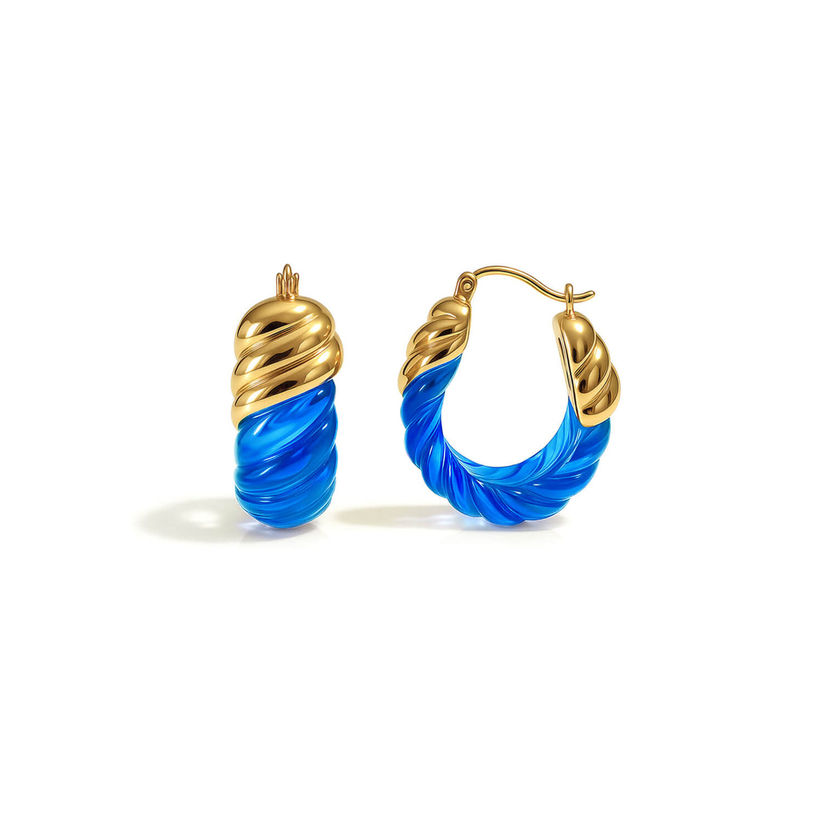 Gold and blue hoop earrings on a white background