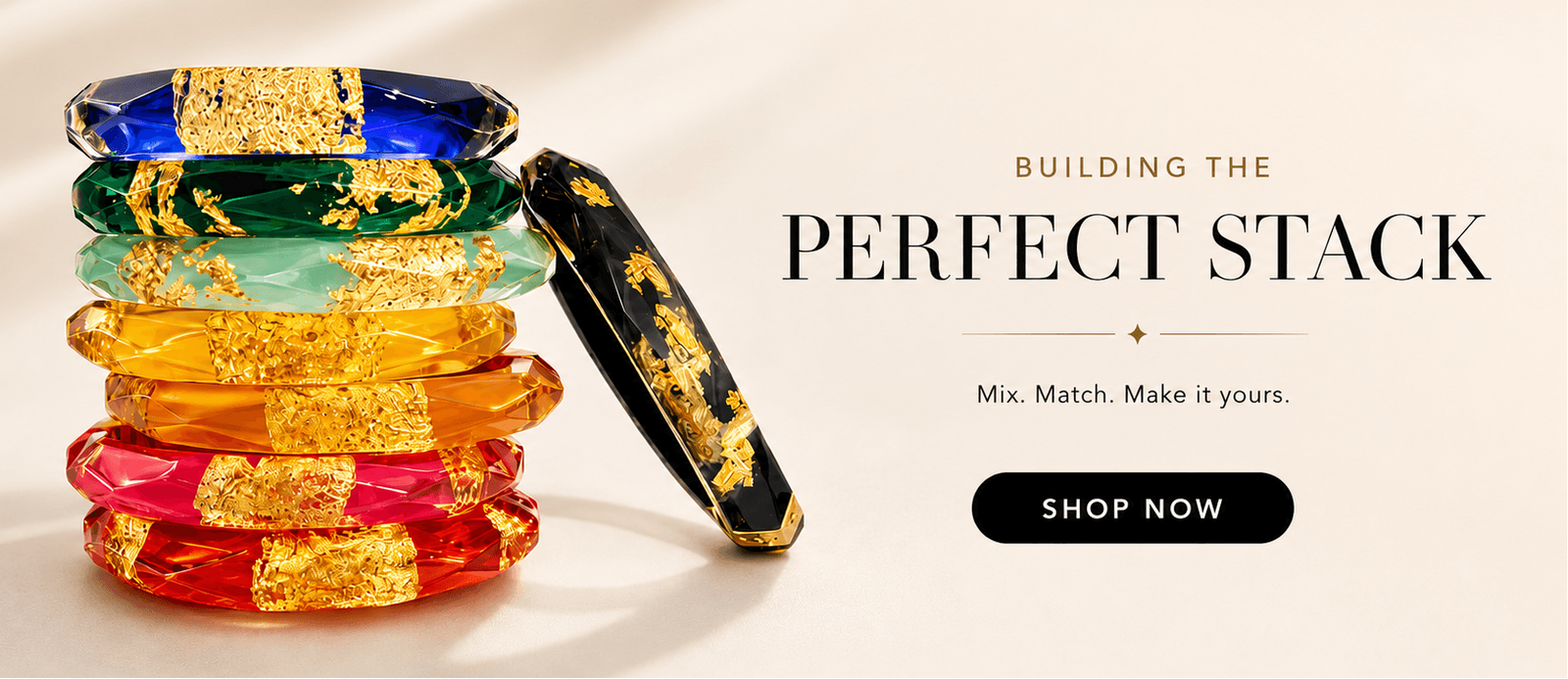 Stack of colorful bangles with text 'Building the Perfect Stack' and 'Shop Now' button on a light background