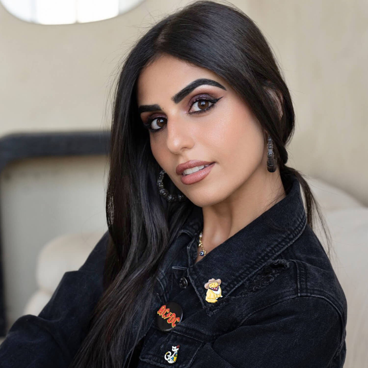 Pair of textured black bamboo hoop earrings on a white background